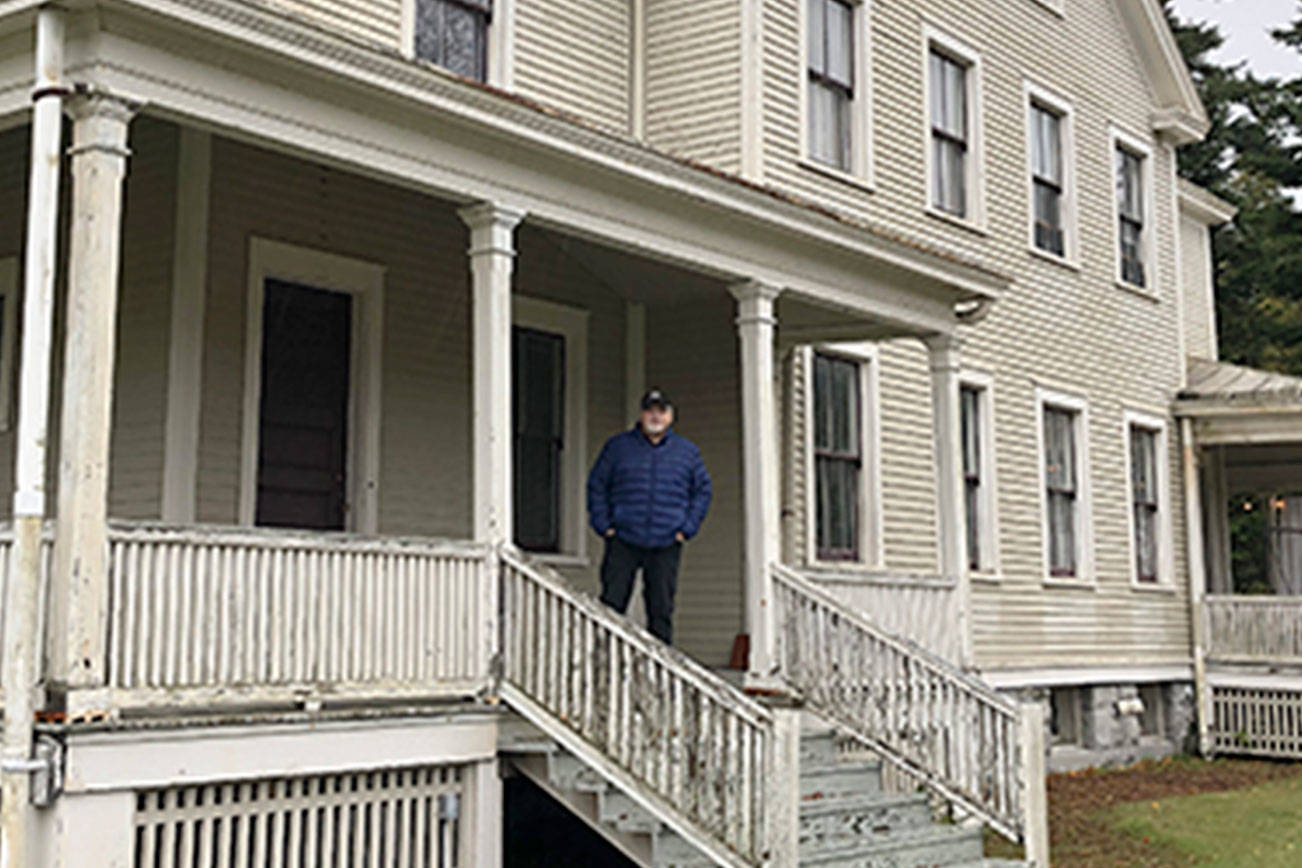Doug Kroon stands on the porch of the old officer’s house at Camp Casey where his family once lived