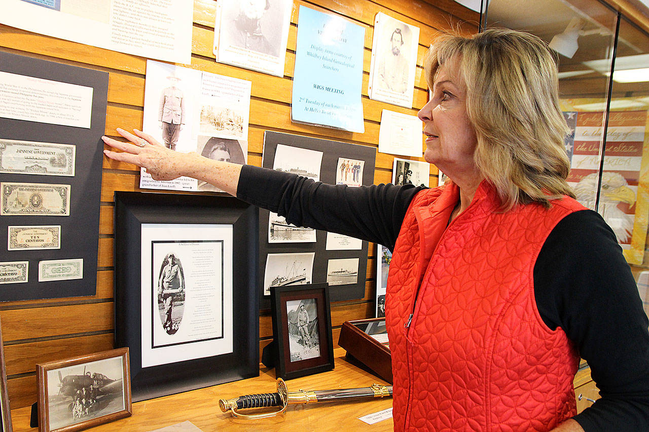 Photo by Laura Guido/Whidbey News-Times                                Jackie Vannice, president of the Whidbey Island Genealogical Searchers, points to a display the club recently established at the Oak Harbor Library to honor veterans.
