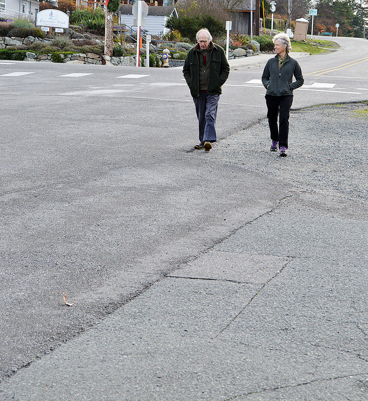 Jay Adams and Ruth Richards walk on the section of Alexander Street in Coupeville that doesn’t have a sidewalk. The town recently received a grant to finish the one block of sidewalk. Photo by Laura Guido/Whidbey News-Times