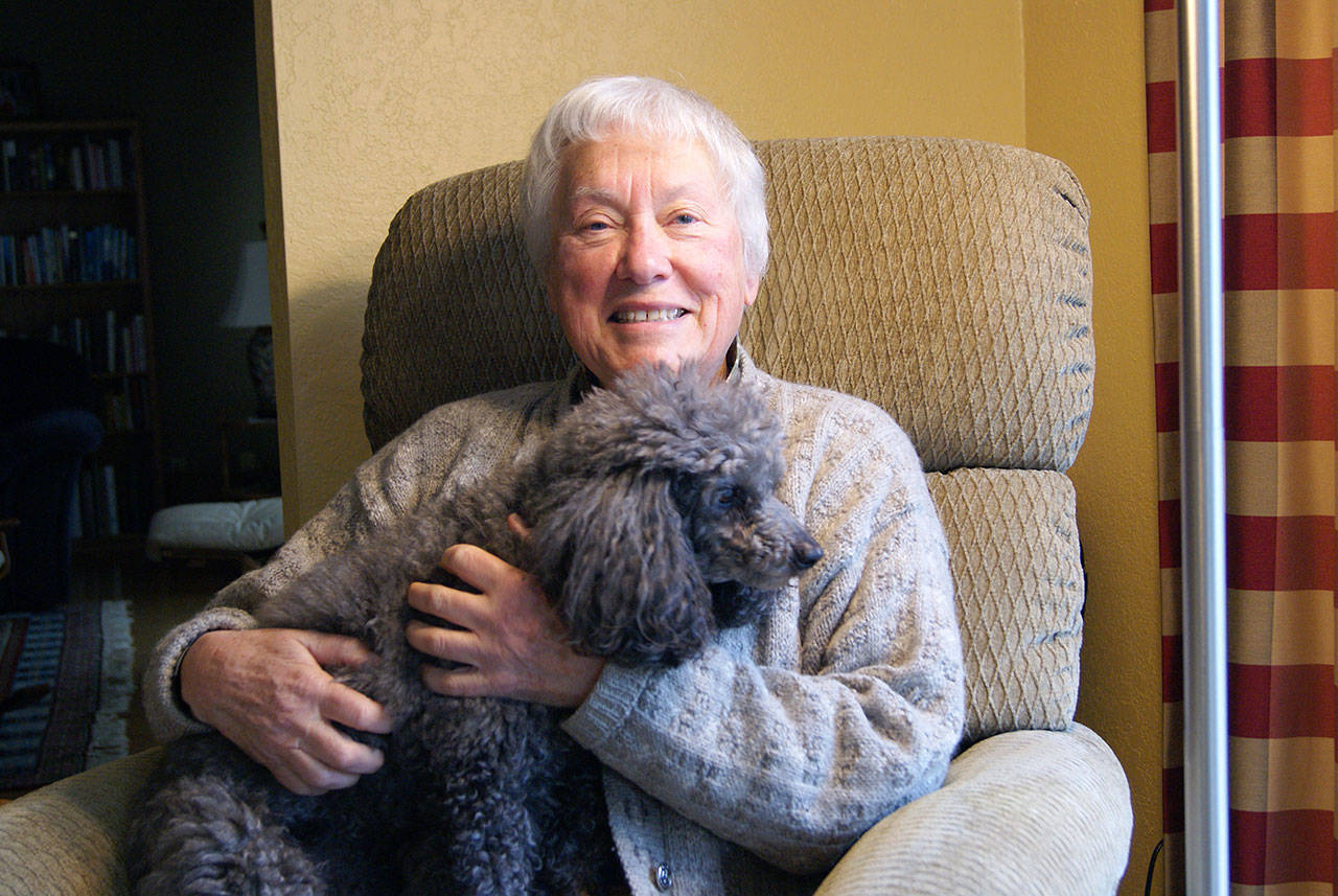 Photo by Maria Matson/Whidbey News Group.                                South Whidbey veteran Jill Johnson holds her miniature poodle, Sophie.