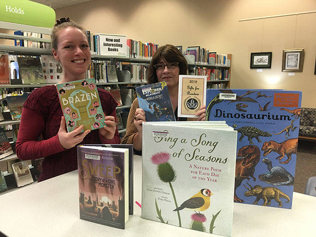 Photo provided.                                &lt;em&gt;Oak Harbor Teen Librarian Jessica Aws, left, and Librarian Jane López-Santillana show off some of the books that are included in the “2018 Gifts for Readers” recommendation list.&lt;/em&gt;