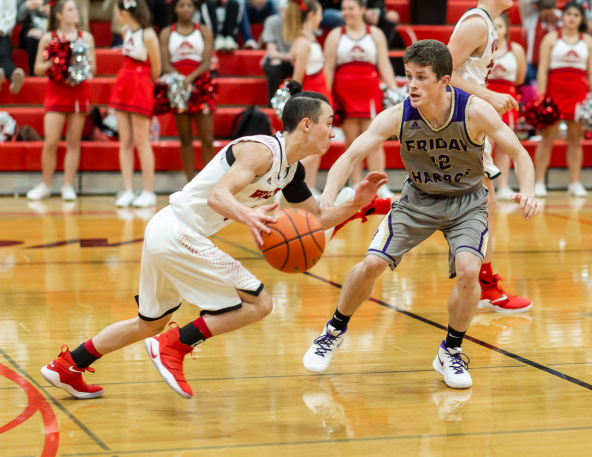 Coupeville’s Jered Brown, left, attempts to beat Friday Harbor’s Ethan Germain off the dribble. (Photo by John Fisken)