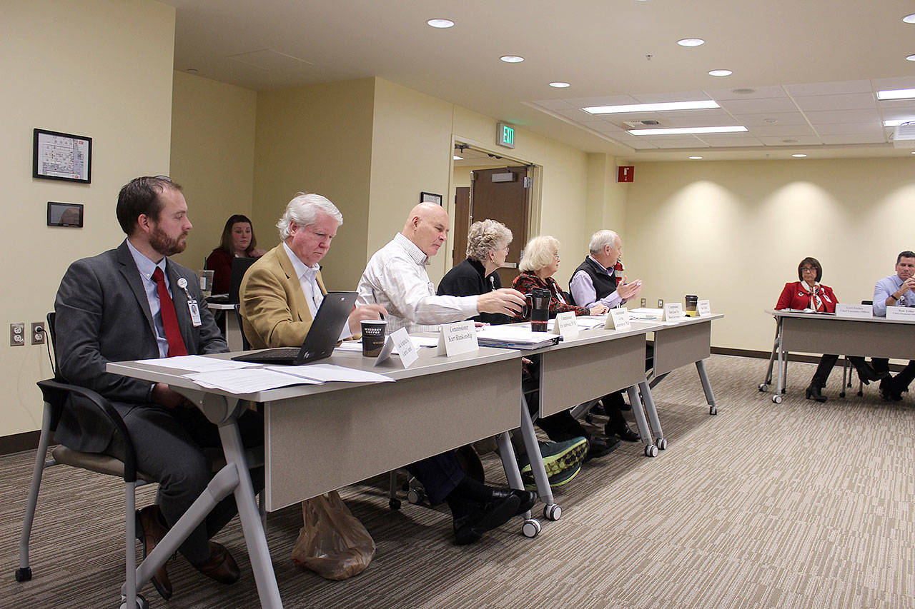 WhidbeyHealth board of commissioners, seated in the new Robert and June Sebo Health Education Center, look over next years budget. (Photo by Patricia Guthrie/Whidbey News Group)