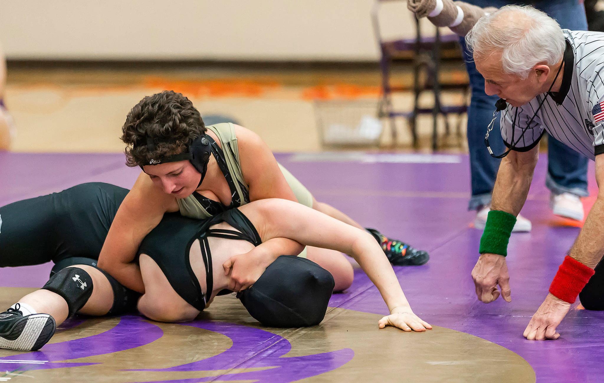 Taylor Cress, top, works for a pin in one of the three matches she won Wednesday.(Photo by John Fisken)