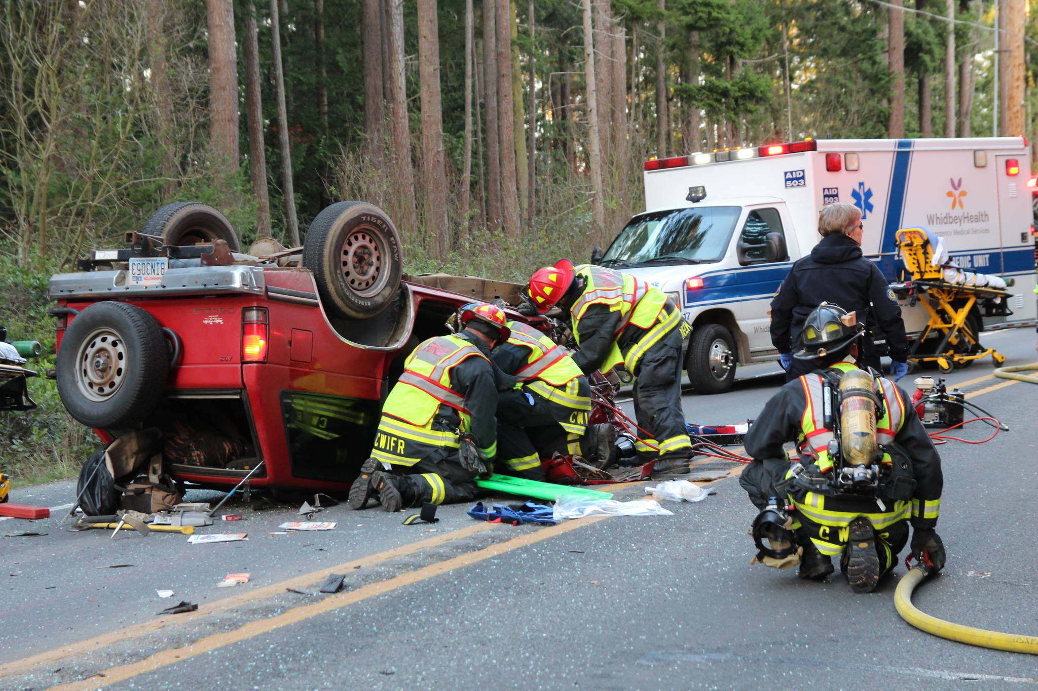 Photo by Jessie Stensland                                Firefighters work to extract the driver of a vehicle involved in a head-on crash.