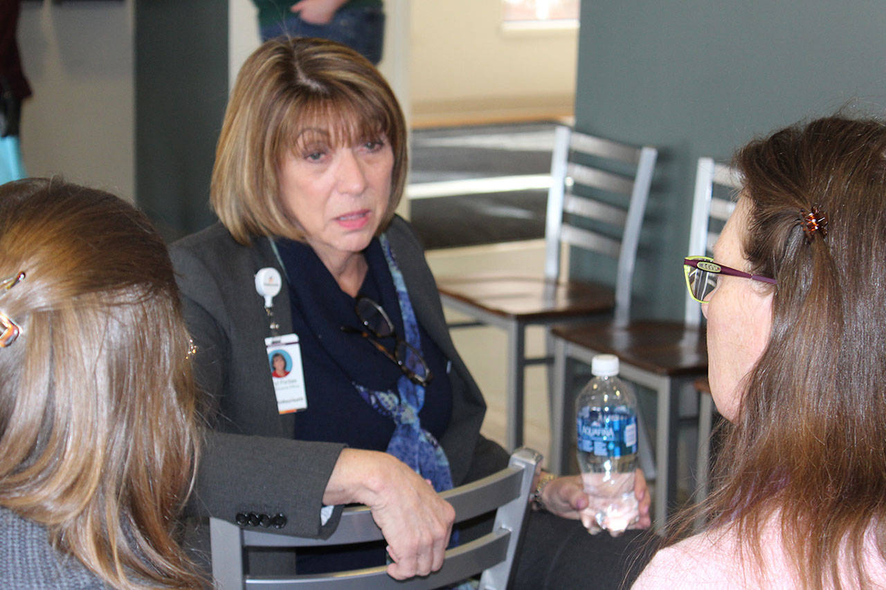 WhidbeyHealth CEO Geri Forbes meets with people after a public hearing earlier this year. (File photo)