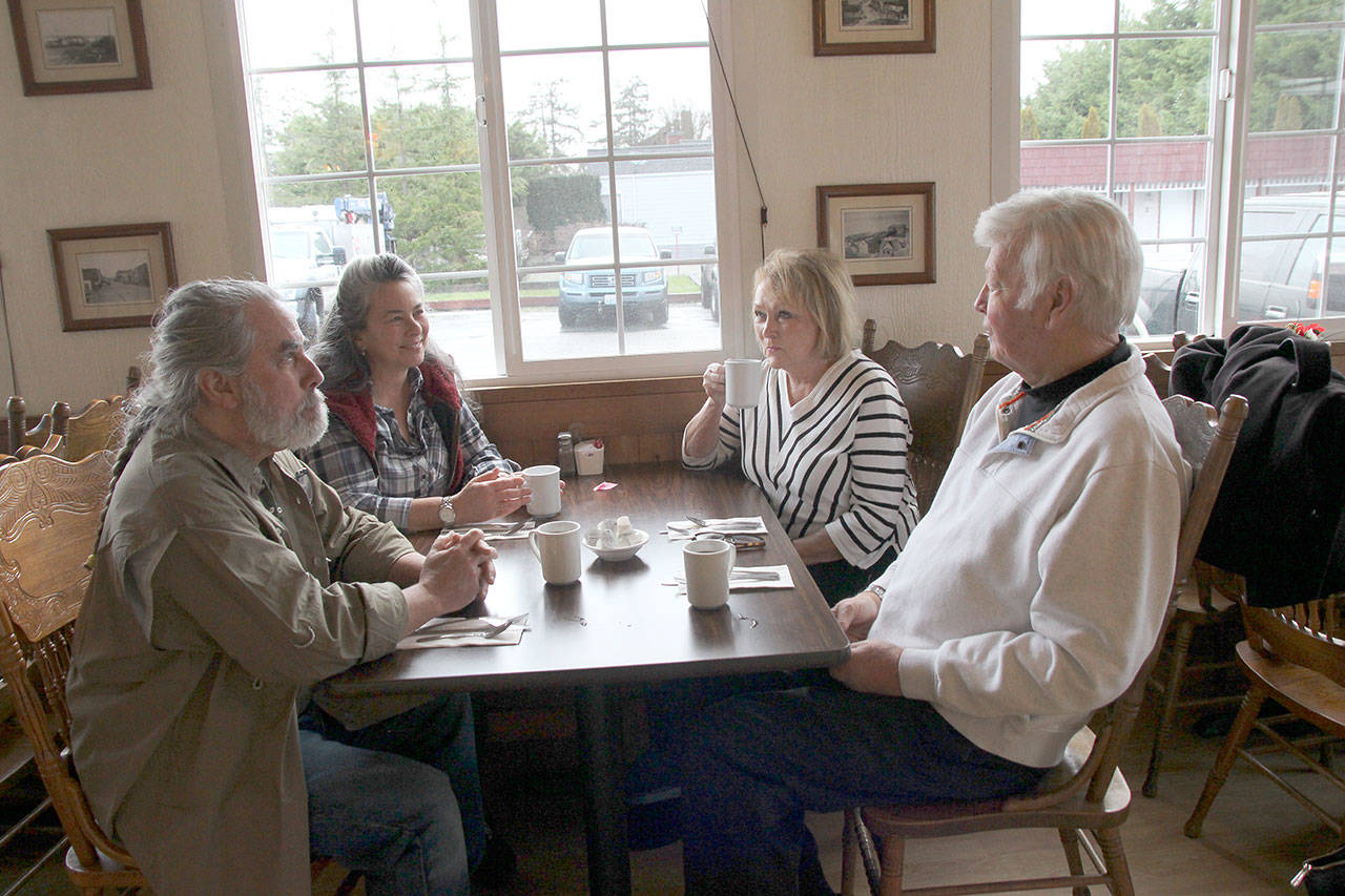 Photo by Jessie Stensland / Whidbey News-Times.                                Alan Licht and Erlinda Shery, the new owners of the Tyee Restaurant, have coffee with Suzanne and Steven Hallen, who owned the diner for 20 years.