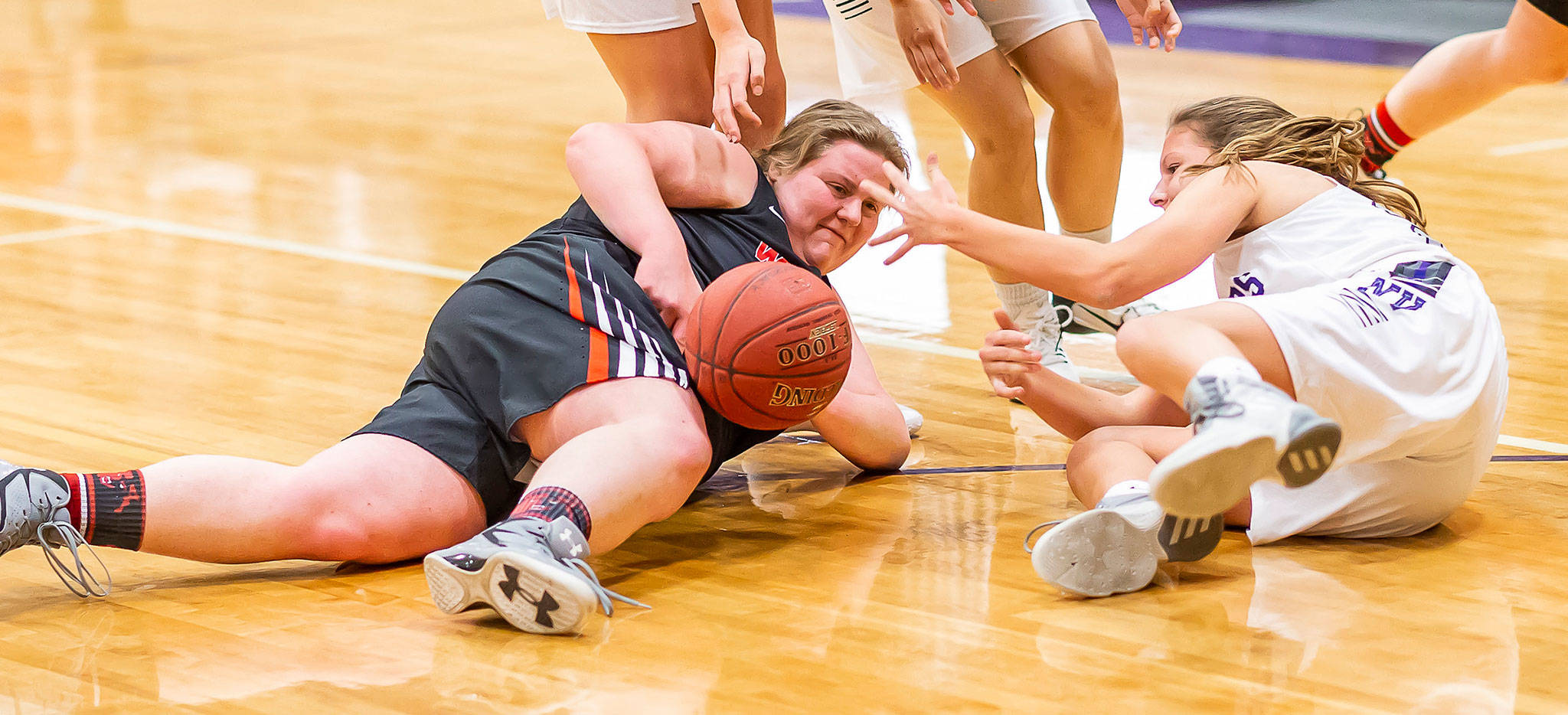 Coupeville’s Nicole Laxton, left, hits the floor to secure a loose ball.(Photo by John Fisken)