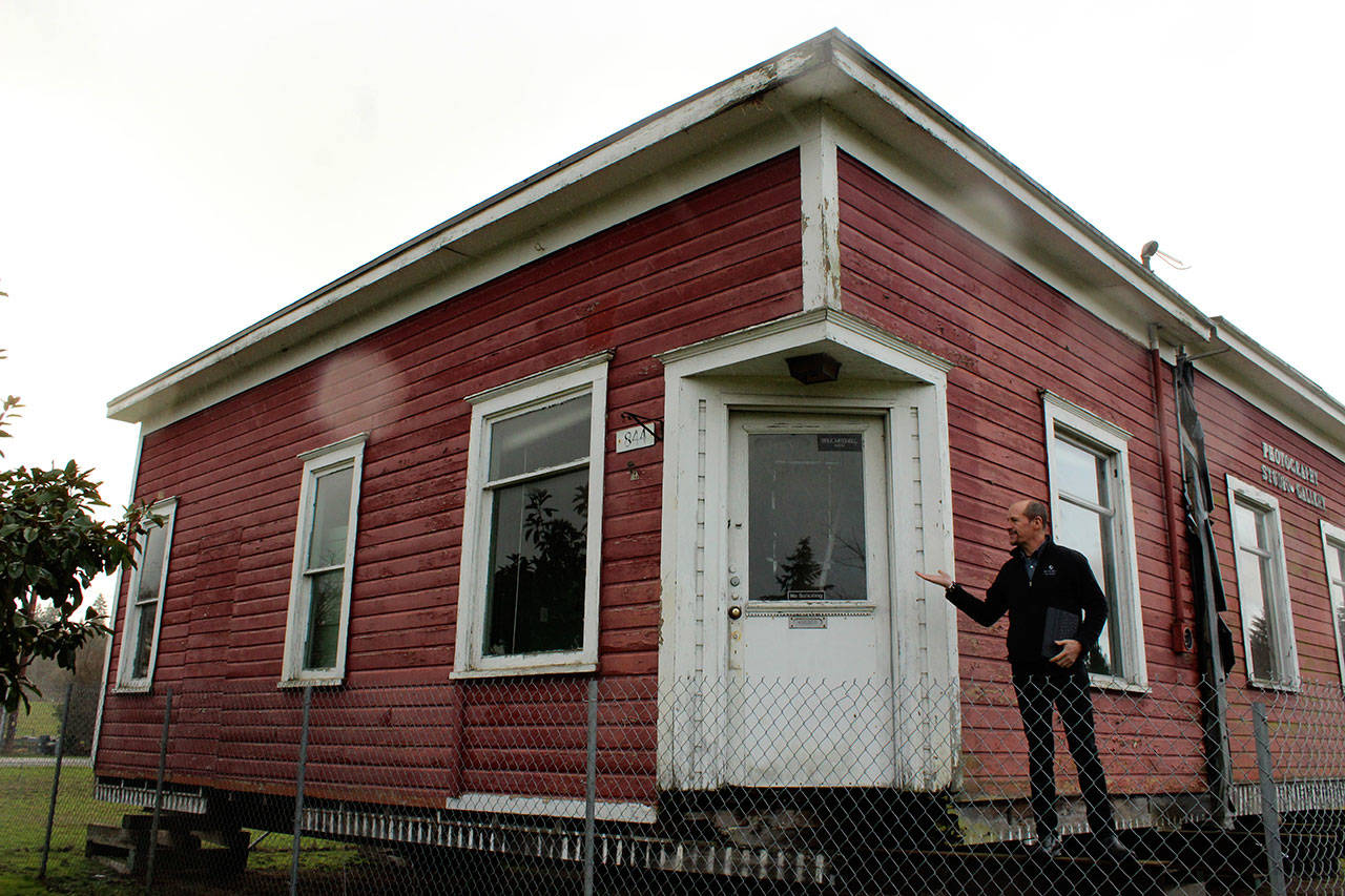 Whidbey Telecom’s George Henny in front of South Whidbey’s original telephone building built in 1913. (Photo by Patricia Guthrie/Whidbey News Group)
