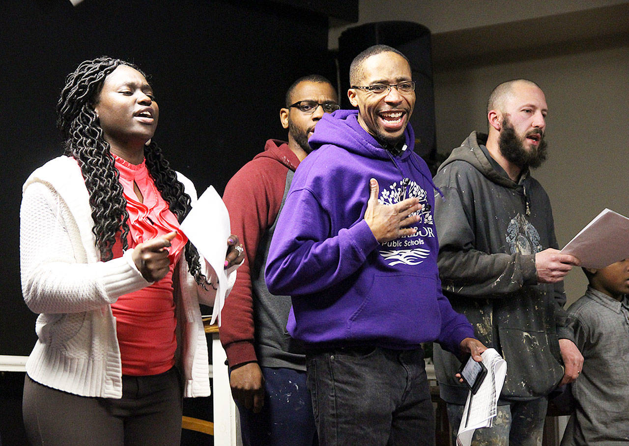 Unity Choir members Wismine Davilar, far left, Tyrone Vester, center front, Josh Jackson, center back, and Jarrod Stafford rehearse Thursday night for the annual Martin Luther King Jr. service, which is set for 3 p.m. Sunday at House of Prayer in Oak Harbor. Photo by Laura Guido/Whidbey News-Times