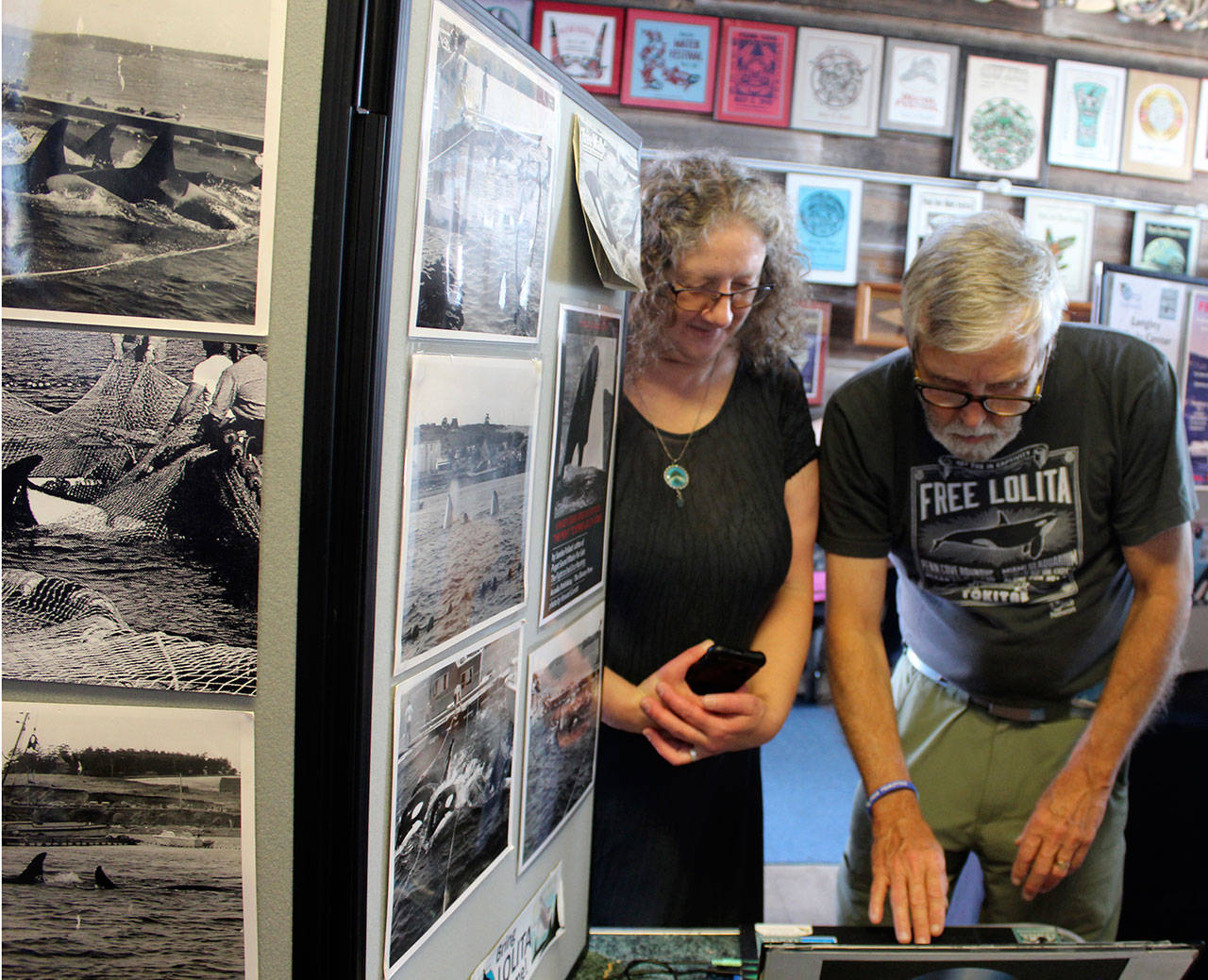 Orca Network’s Susan Berta and Howard Garrett have led the fight to return Lolita to her home waters of Puget Sound. In August 2018, they set up an educational display about the killer whale round-ups on Coupeville wharf before leading a commemorative ceremony honoring captured and deceased orcas. (Photo by Patricia Guthrie/Whidbey News Group)