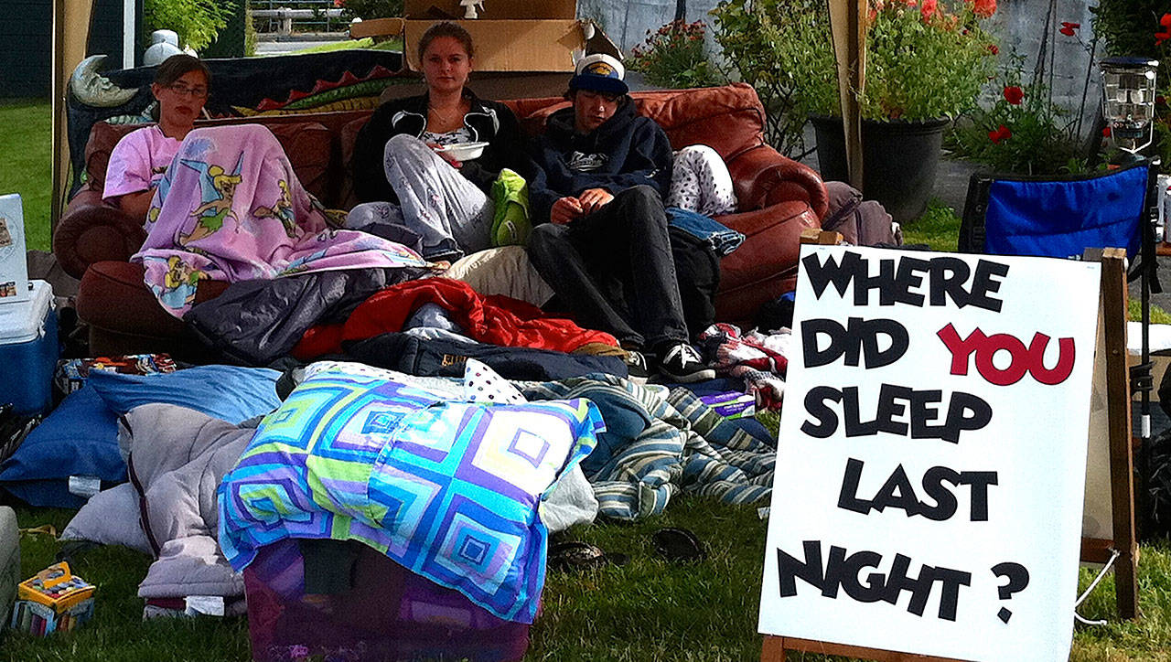 Ryan’s House for Youth has taken its beloved “big red” couch various places, including sleeping in front of Langley City Hall to raise awareness. Pictured is the couch and youth during the Chochokum Arts Festival in July 2011. Photo provided
