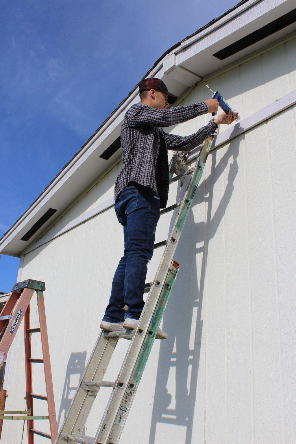 Photo by Patricia Guthrie/Whidbey News-Times. Cameron Toomey-Stout helped weatherproof a house during last year’s Central Whidbey Hearts Hammers Work Day.