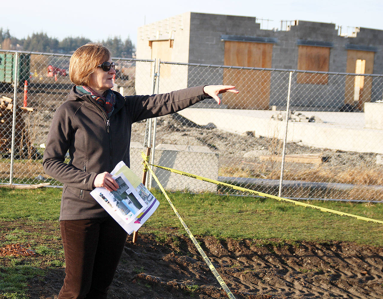 Ellen White, a fundraising chairwoman for the Bailey Johnson Playground Improvement Committee, explains the new planned layout for the updated playground commemorating a 4-year-old Oak Harbor girl who died in 2002. The toddler play area will open with the re-opening of Windjammer Park in July. Photo by Laura Guido/Whidbey News-Times