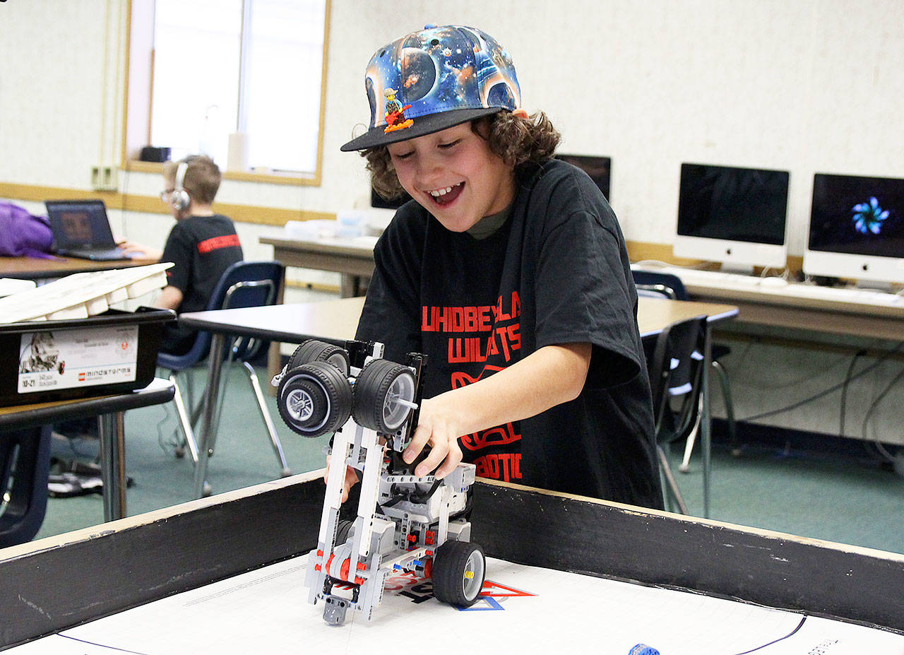 Home Connection FIRST Lego League member Tobias Wood tries to solve a problem after the robot he programmed didn’t successfully complete its mission. Photo by Laura Guido/Whidbey News-Times