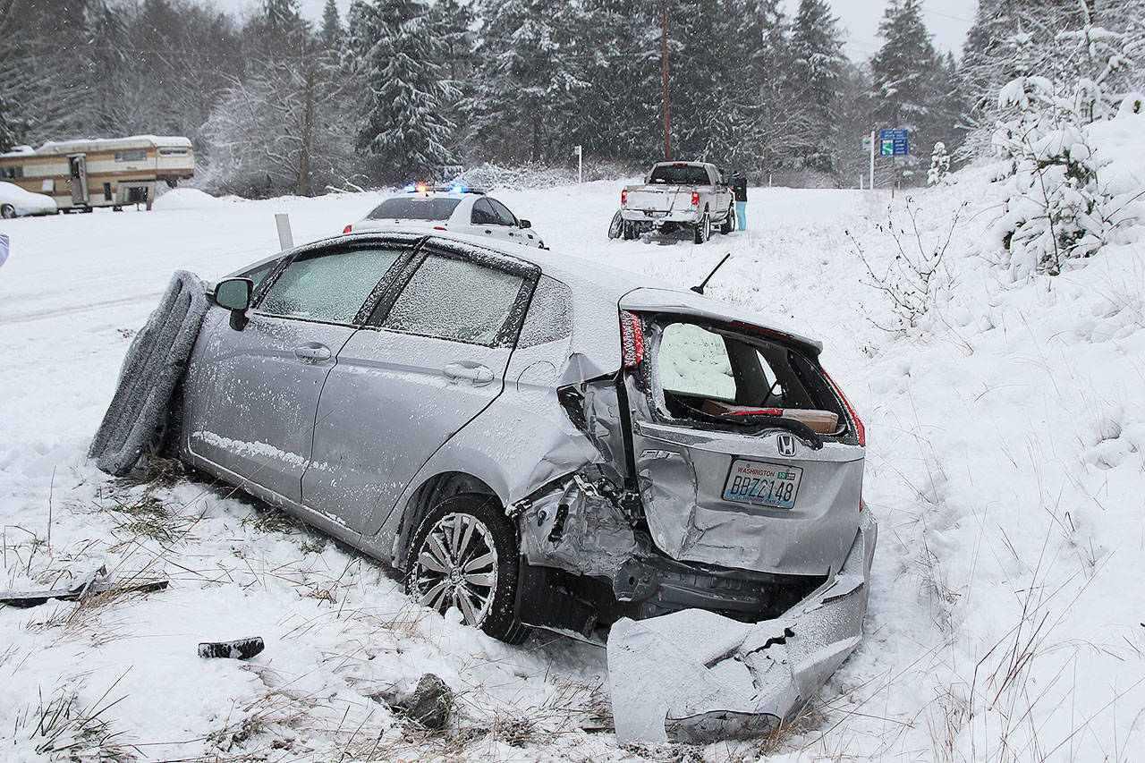 A collision occurred Monday morning as a car slid into Highway 20 from Race Road in Central Whidbey. An oncoming pickup on the highway struck the car, causing it to go into a ditch. No injuries were reported at the incident. Photo by Laura Guido/Whidbey News Group
