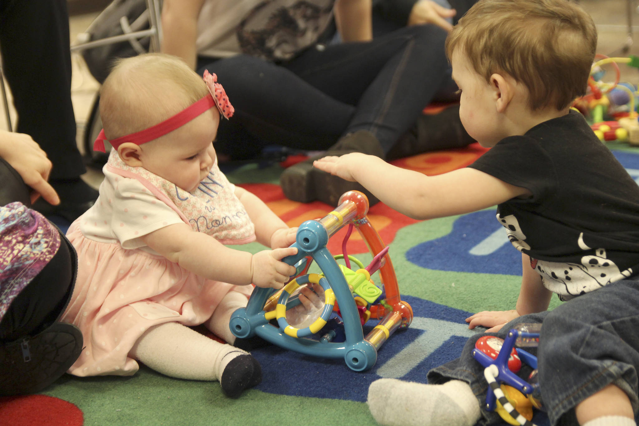 Rebekah Reisen, 6 months old, plays with other children at Baby Storytime. “I like that it’s not just reading, I like that she can interact with other little babies. She just loves it,” said Rebekah’s mother, Elizabeth Reisen, of Oak Harbor.
