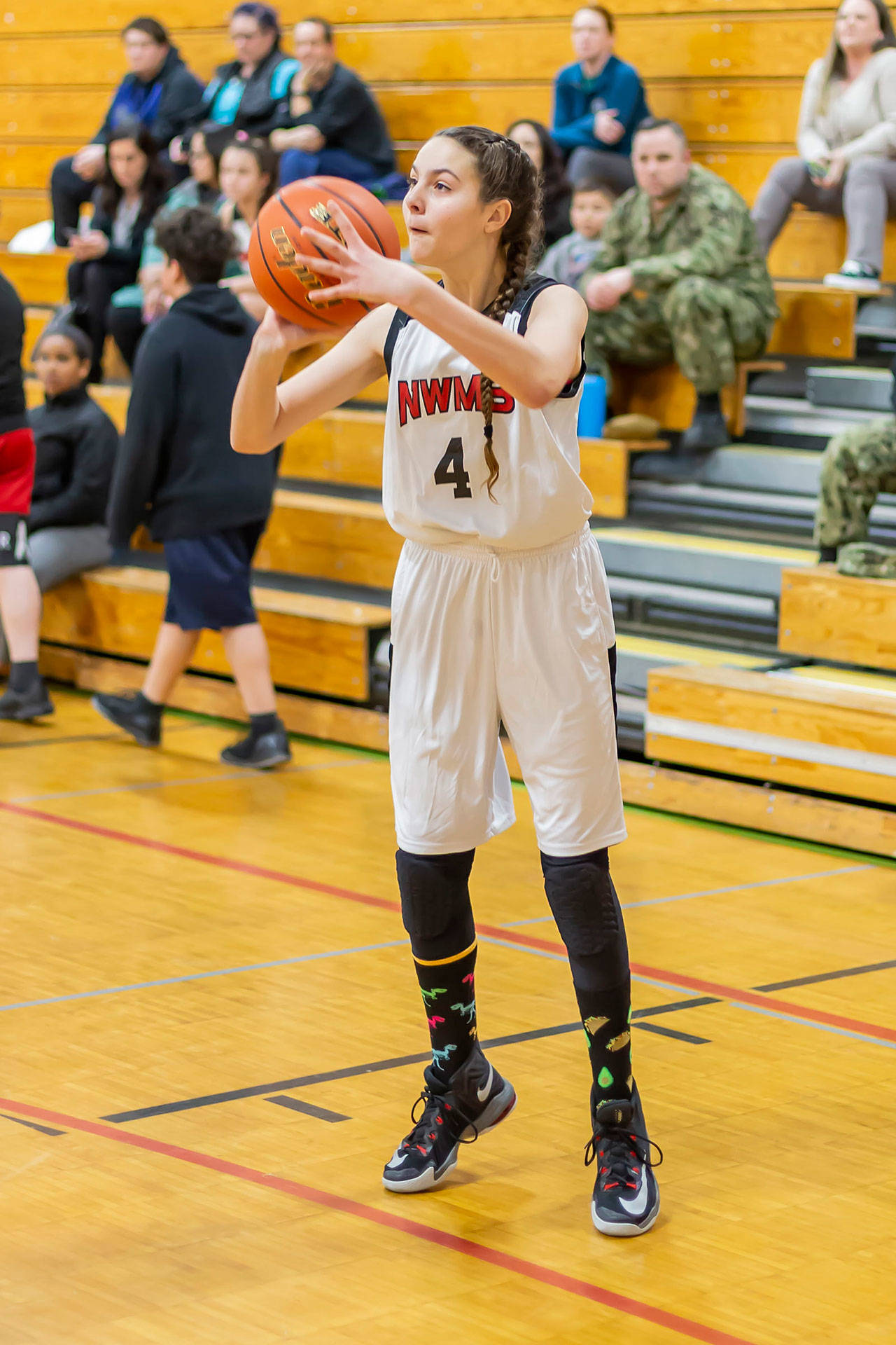 Analeah White puts up a three-point shot in the seventh-grade game.(Photo by John Fisken)