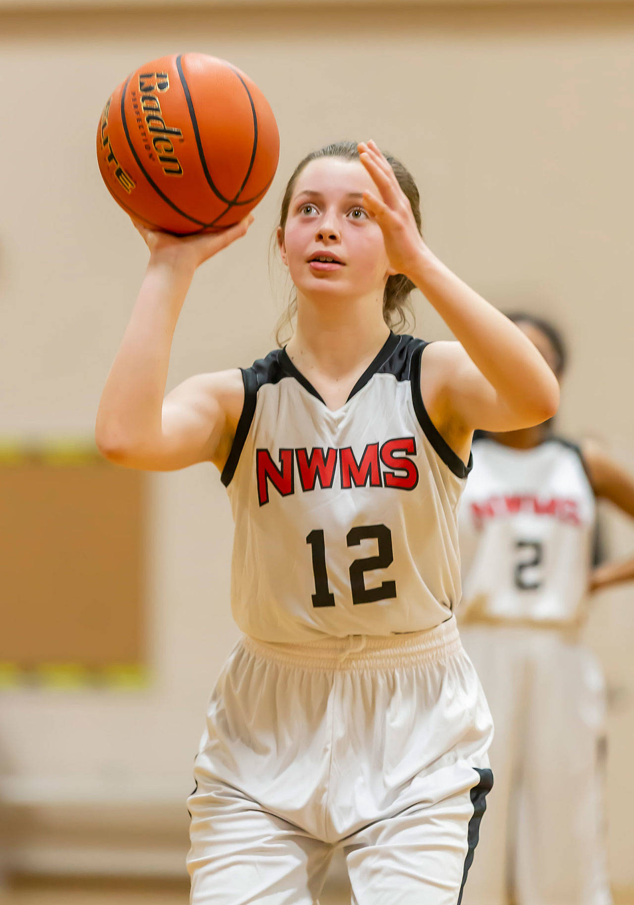 Claire Paul shoots a free throw for the seventh-grade Cougars.(Photo by John Fisken)