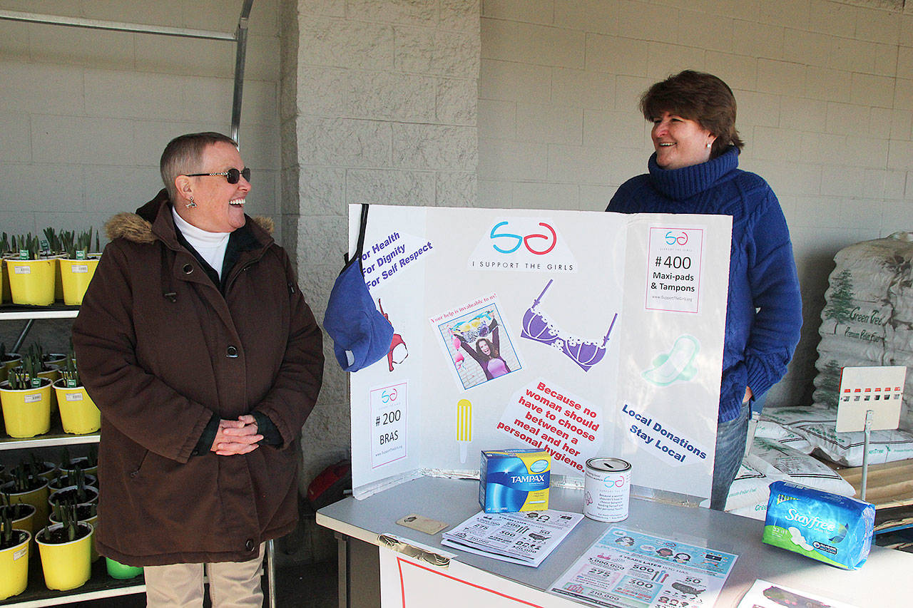 Kate Mistler, right, and Kristi Lovelady stand outside Walmart Tuesday to collect bras, tampons and sanitary pads for local women in need. Mistler is working to bring the organization I Support the Girls to Whidbey Island to ensure the effort is ongoing. Photo by Laura Guido/Whidbey News Group