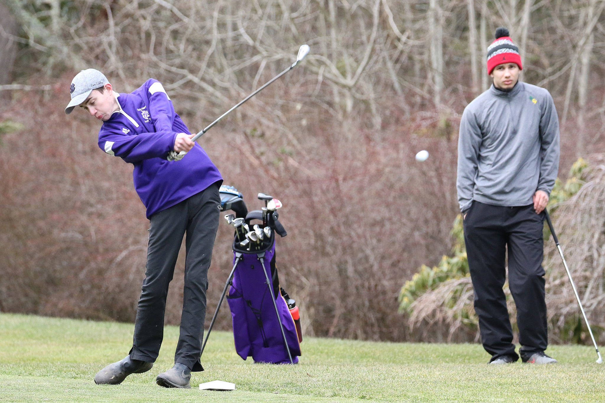 Nick Krantz tees off at the third hole as teammate Haven Brown looks on.(Photo by John Fisken)