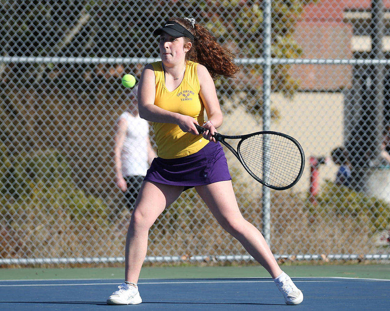 Annie Salinger slaps a backhand in her win in third singles Monday.(Photo by John Fisken)