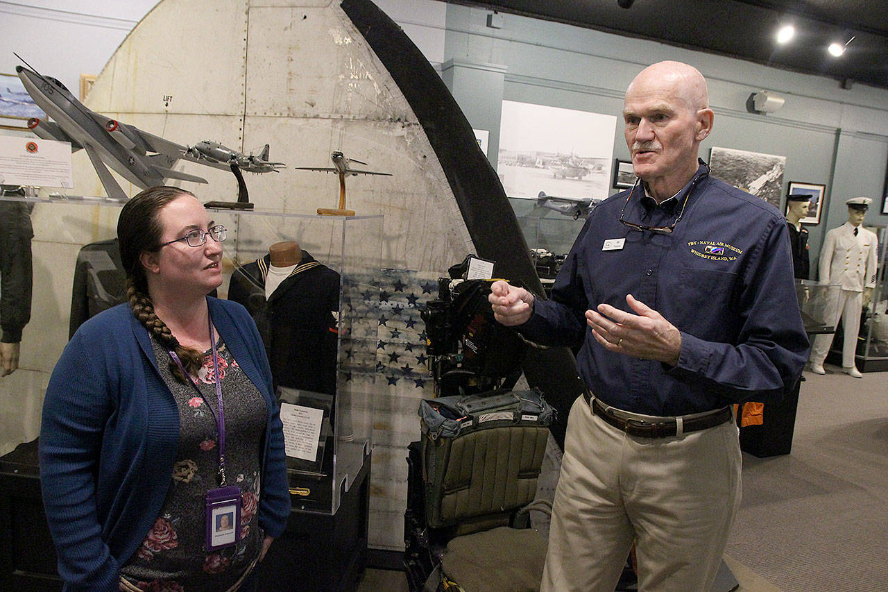 Stephanie Ashcroft, Sunrise Services Health Home care coordinator, listens to Wil Shellenberger, president of the PBY Memorial Foundation, as he gives her a tour of the PBY Naval Air Museum. The foundation, with a monetary donation from State Farm, provided Ashcroft with 200 tickets so her Health Home clients could visit the museum for free. Photo by Laura Guido/Whidbey News-Times