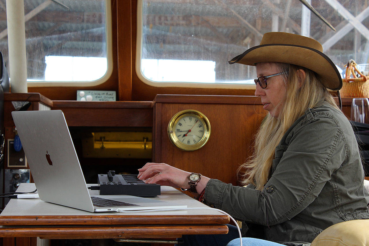 Holly Chadwick plays electronic piano aboard her boat, Rubicon, where she often goes to compose music. The filmmaker has an Amazon Prime series called “Sounds of Freedom” and she’s working on a documentary about mental illness. (Photo by Patricia Guthrie/Whidbey News Group)
