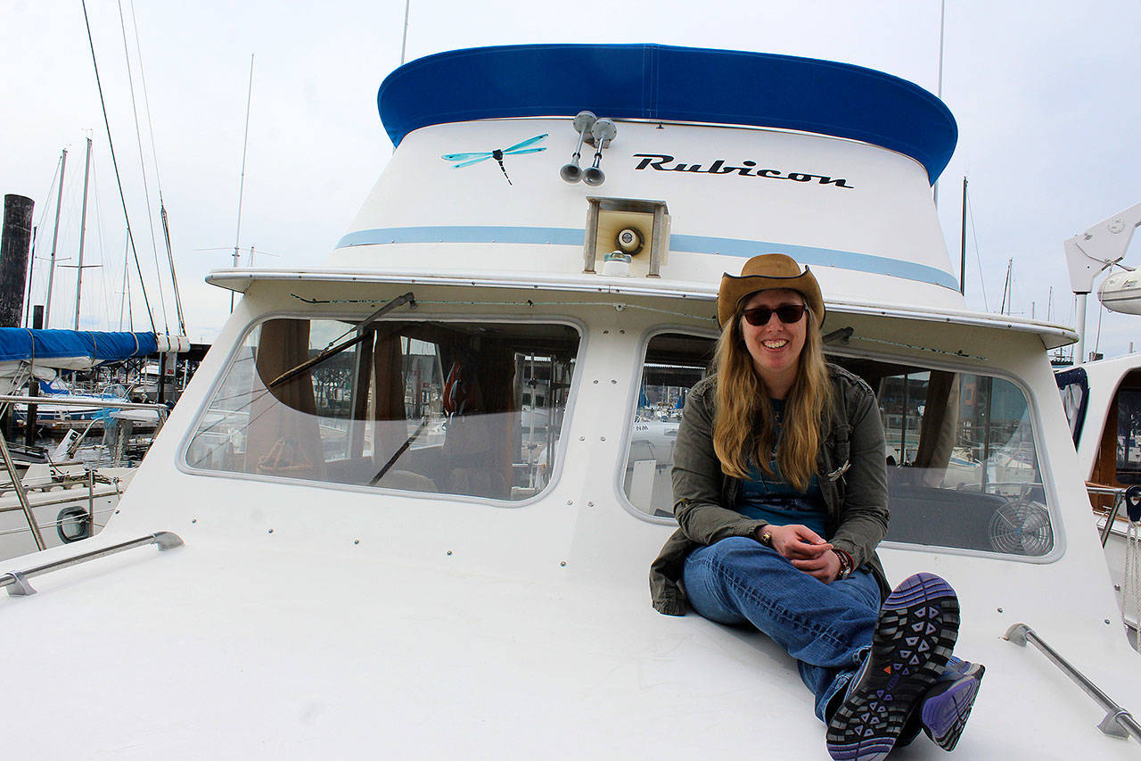 Filmmaker Holly Chadwick sits aboard her boat, Rubicon, at Oak Harbor Marina. Chadwick is featured in a new book about successful women overcoming traumatic experiences. It’s being launched Thursday. (Photo by Patricia Guthrie/Whidbey News Group)