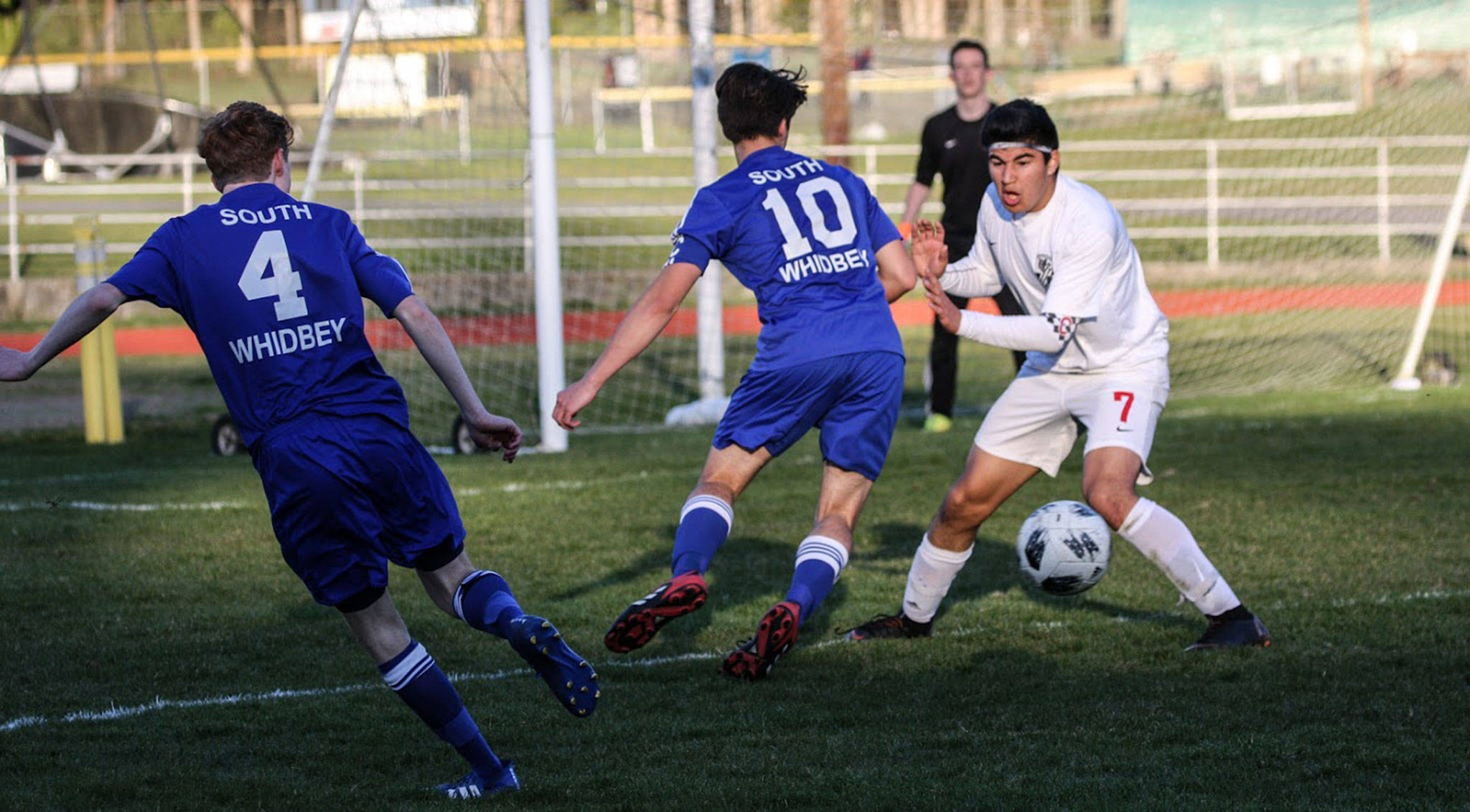 Coupeville’s Aram Leyva (7) faces off with South Whidbey’s Michael Lux (10). (Photo by Matt Simms)