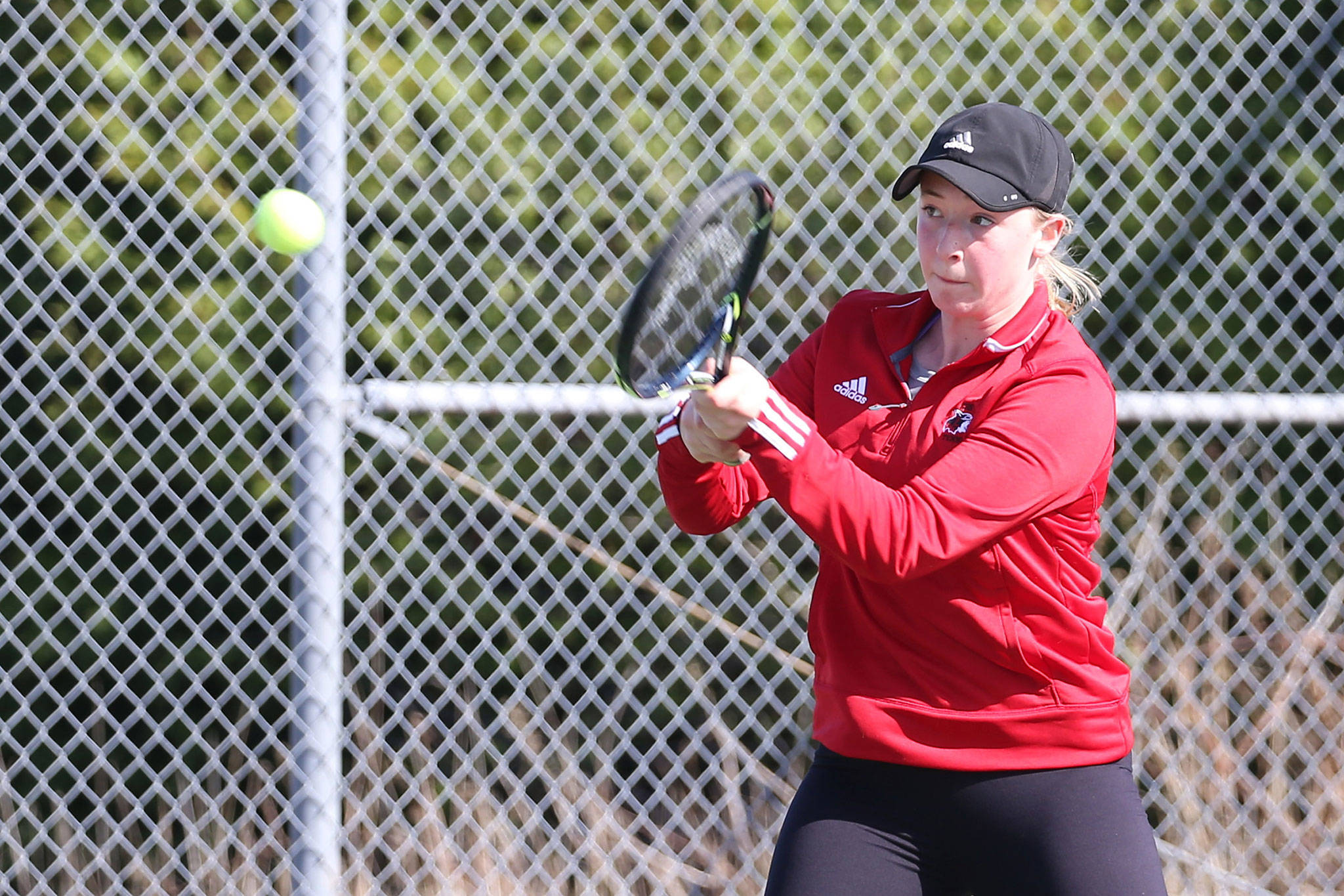 Coupeville’s Jillian Mayne swats a backhand in her second singles match against South Whidbey Tuesday. (Photo by John Fisken)