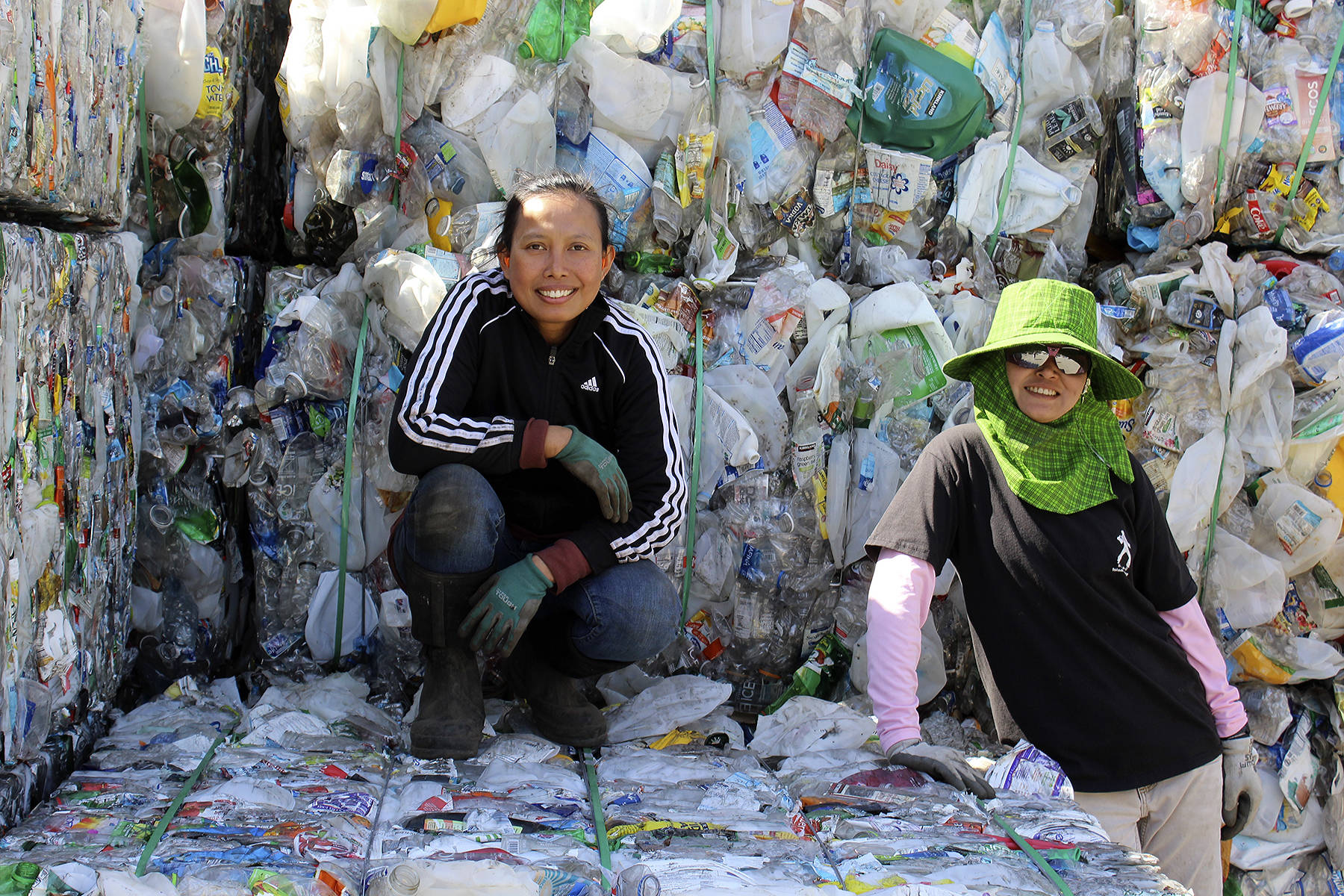 Photos by Patricia Guthrie/Whidbey News Group<em></em>                                <em>Yu Williams, left, and Polly Schweer pose on the mounds of plastic that they bundle to get ready for hauling from Freeland’s Island Recycling. “They are the miracle workers of this place,” says owner Jill Campbell. </em>