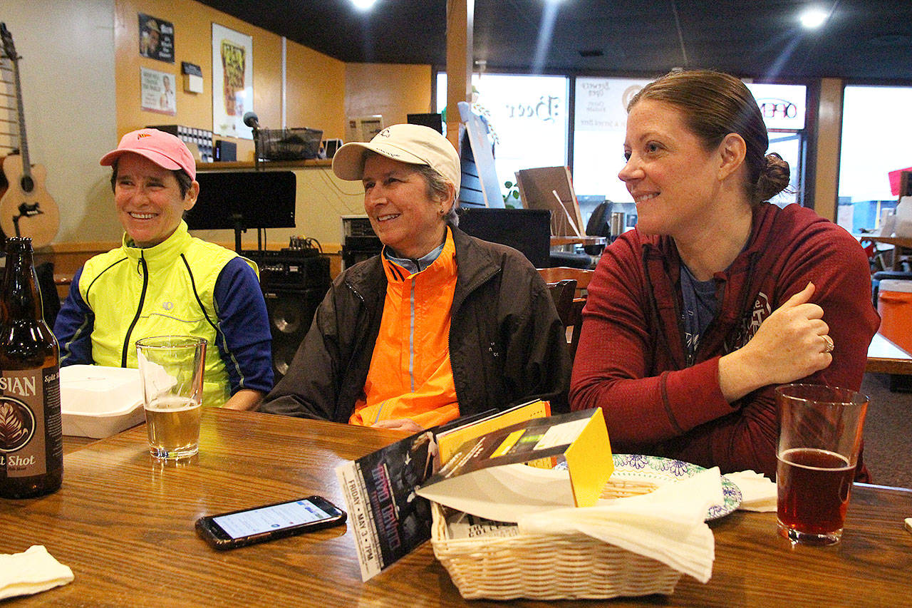 From left, Linda Postenrider, Donna Hinshaw and Angela Lowery hang out with other members of Whidbey Island Run Crew Wednesday night.
