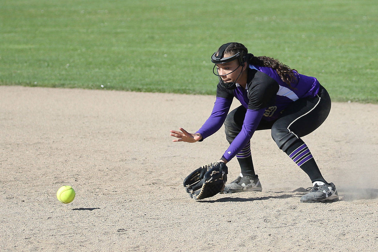 Oak Harbor second baseman Ceirra Dean looks in a ground ball in Mondays game with Meadowdale. (Photo by John Fisken)