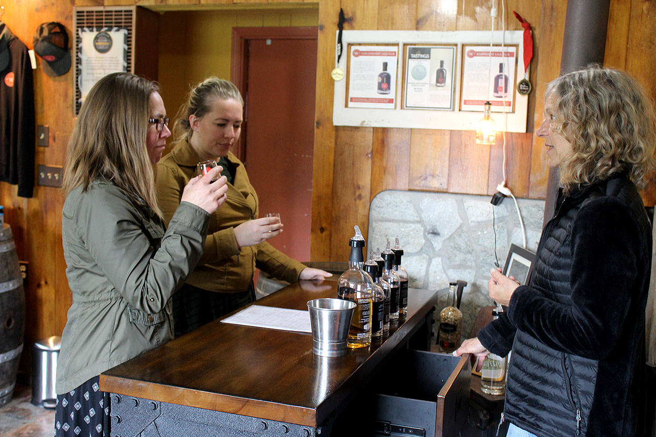 Photo by Patricia Guthrie/Whidbey News Group                                Whidbey Island Distillery spirits guide Michelle Molner serves Katie Kreitzer, left, and Johanna Kreitzer, visitors from Minnesota that stopped in for a tasting Monday.