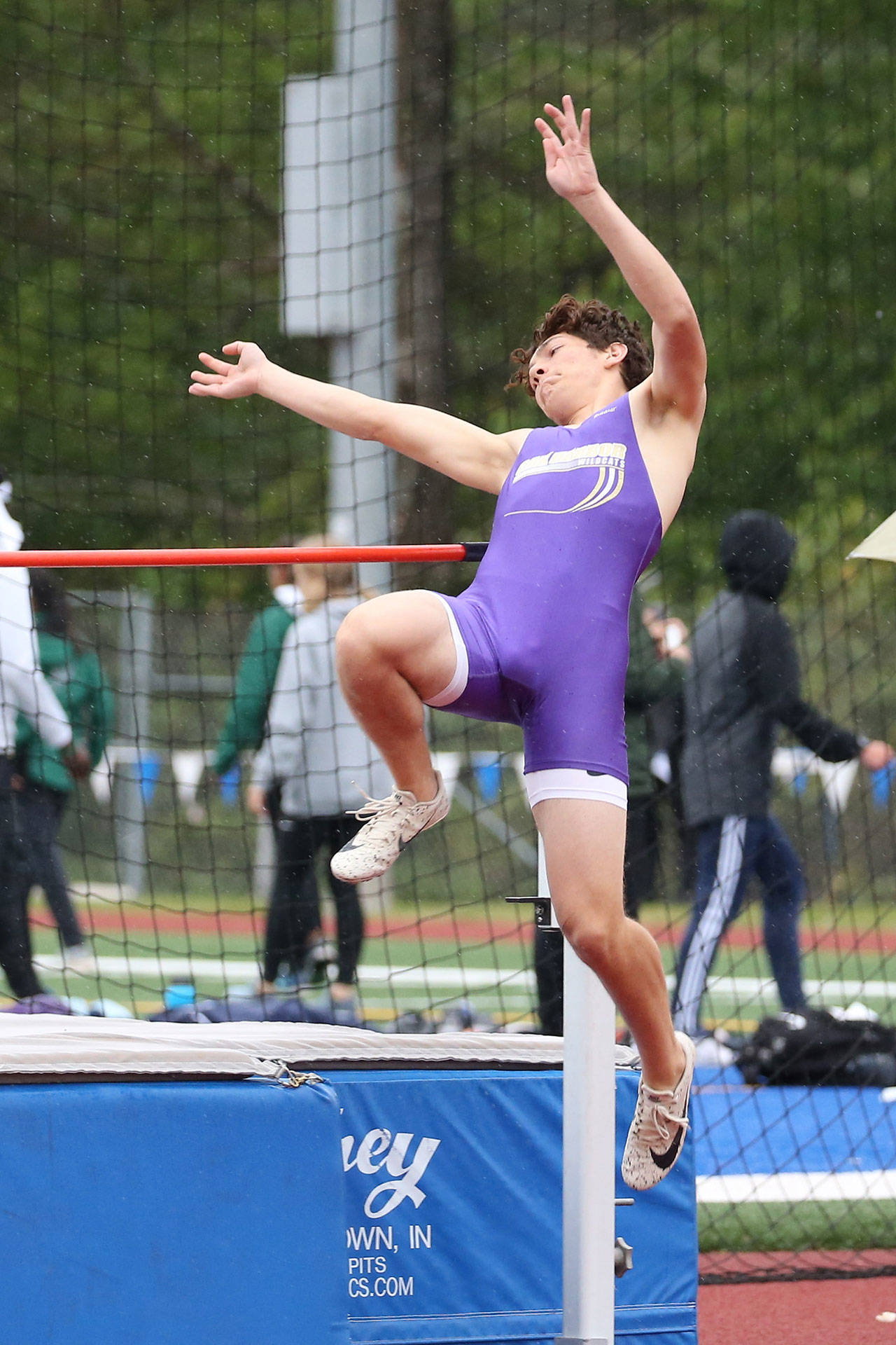 Juan Luna-Elliott leaps to fourth place and a state berth in the high jump.(Photo by John Fisken)
