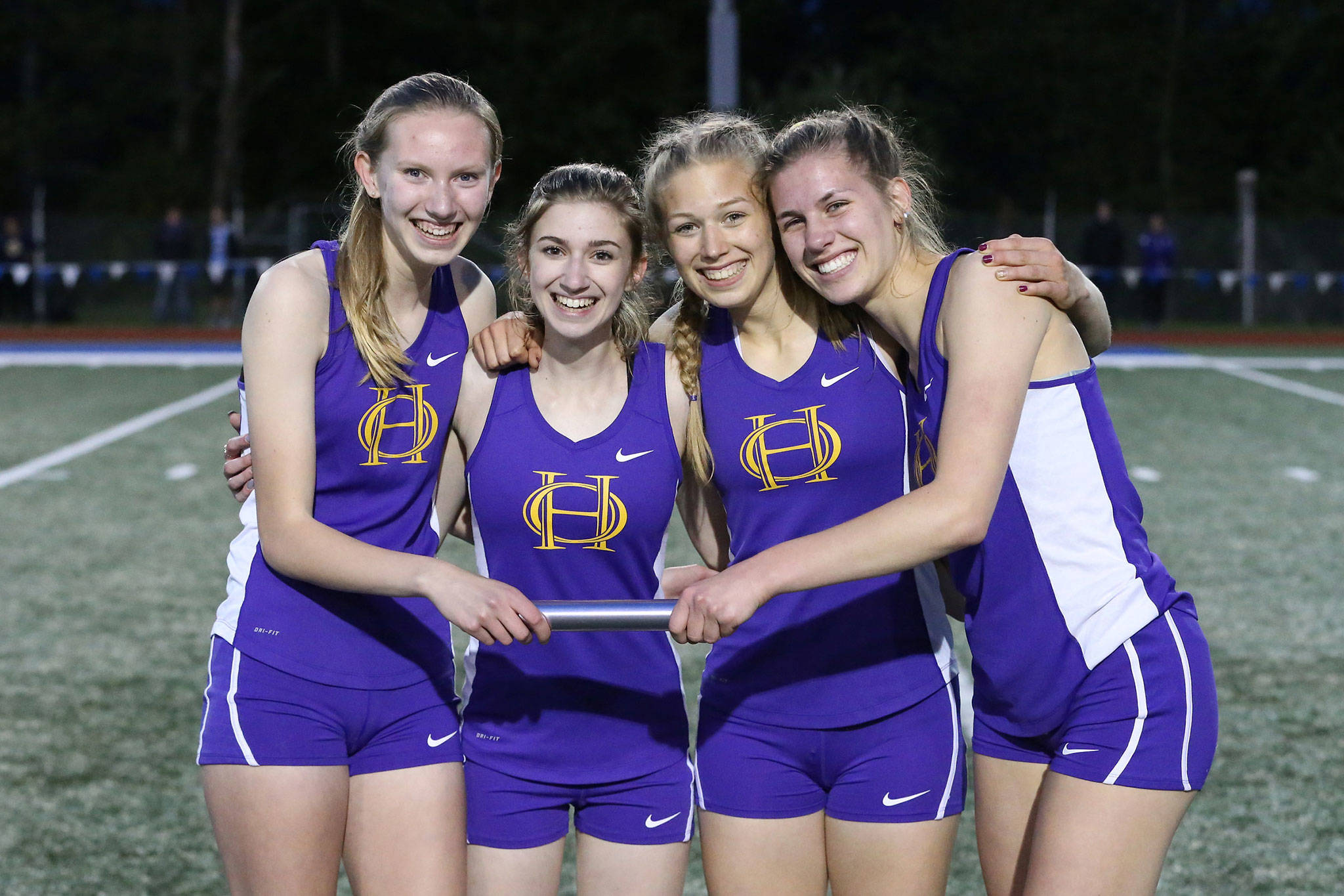 Oak Harbo’s 4x400 relay team of Courtney VanGiesen, left, Brenna Rothman, Natalie Frech and Morgan Pease placed fourth in the district meet, good for a berth in the state meet. (Photo by John Fisken)