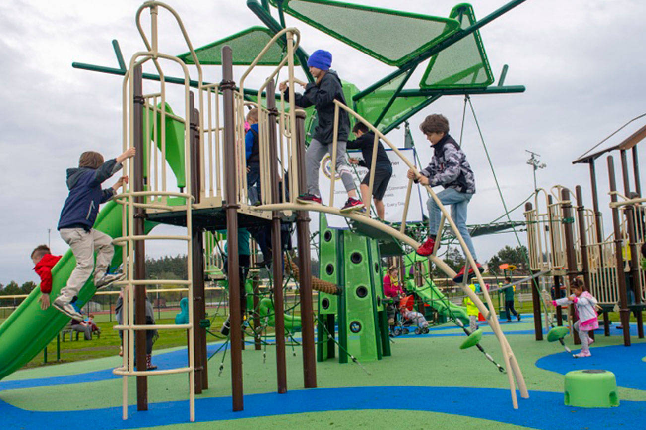 U.S. Navy photo                                Sailors and their families familiarize themselves with the reconstructed playground area at Costen-Turner Memorial Park located on Ault Field at Naval Air Station Whidbey Island.