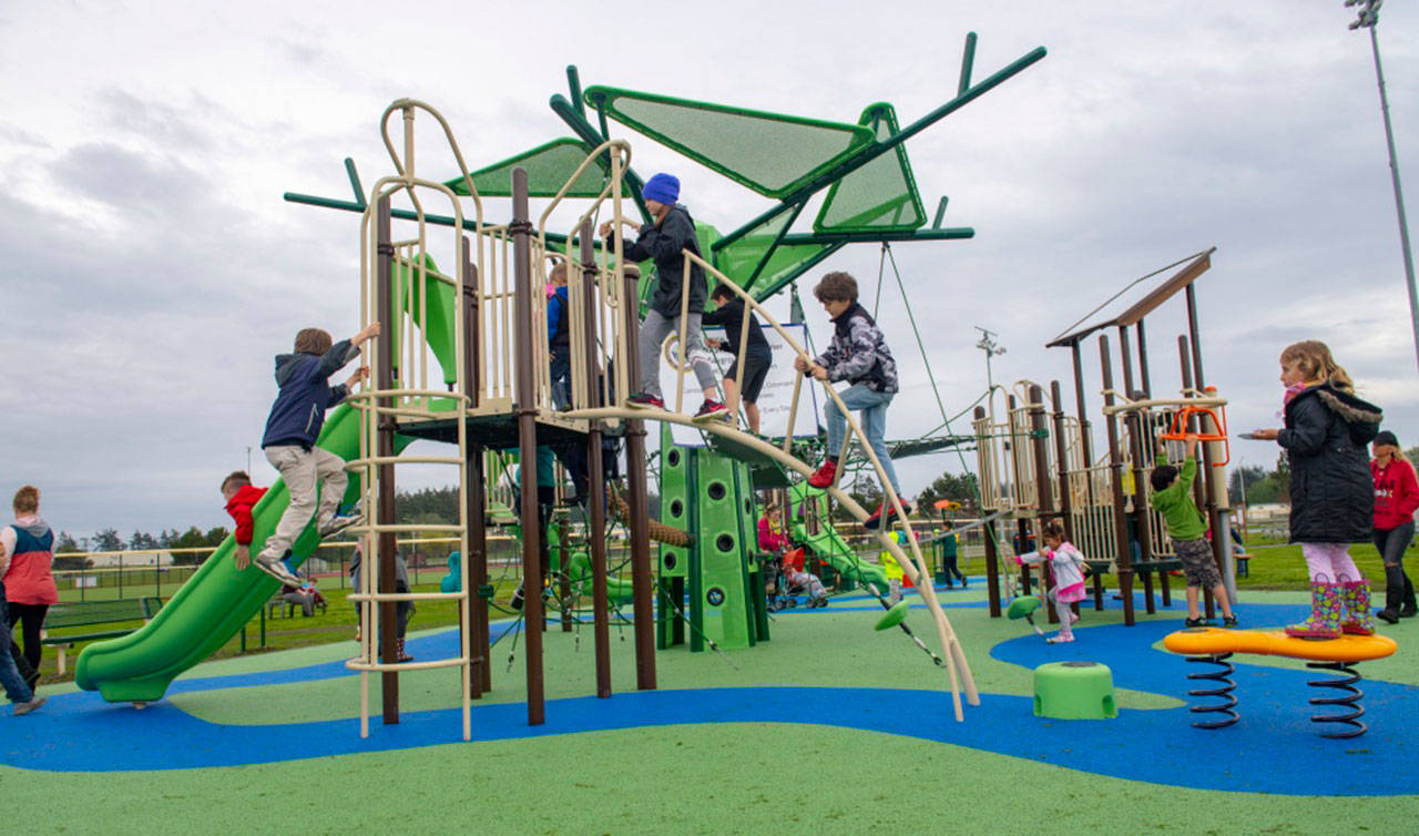 U.S. Navy photo                                Sailors and their families familiarize themselves with the reconstructed playground area at Costen-Turner Memorial Park located on Ault Field at Naval Air Station Whidbey Island.