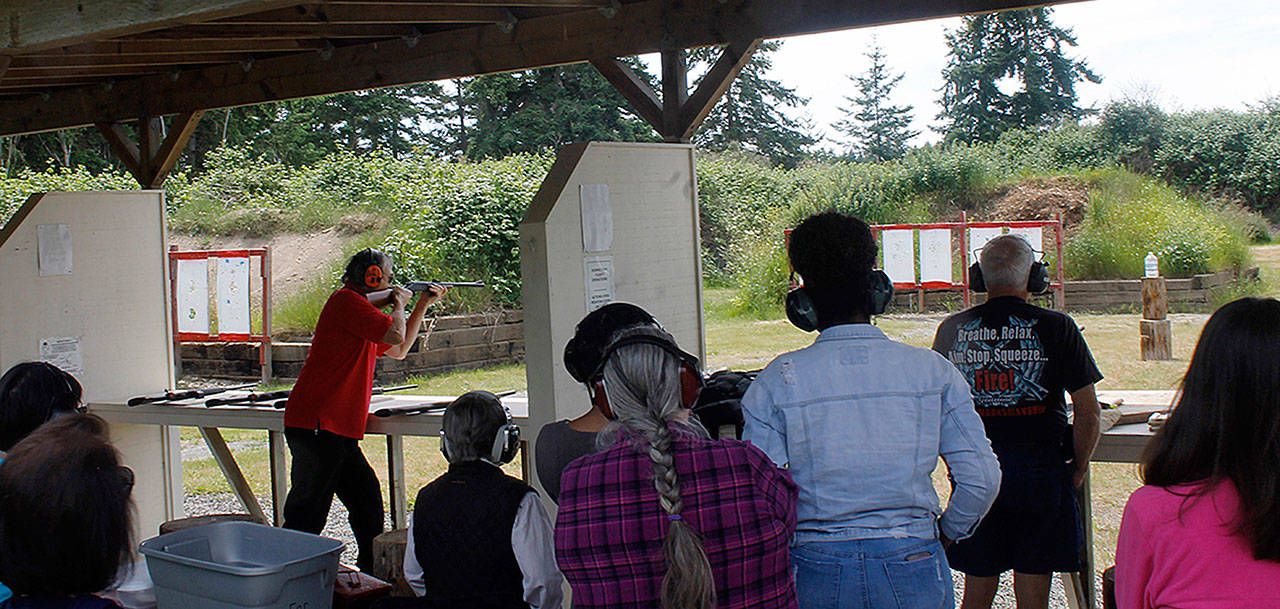 Bob McConchie demonstrates the effects of various types of bullets and firearms during a June 2 instruction session. Photo by Maria Matson/Whidbey News-Times