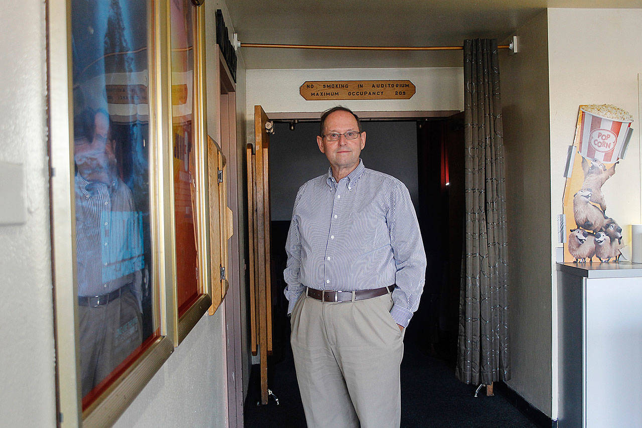 John Solin stands in front of one of the theater rooms at Oak Harbor Cinemas. He has many plans for the theater. Photo by Maria Matson/Whidbey News-Times
