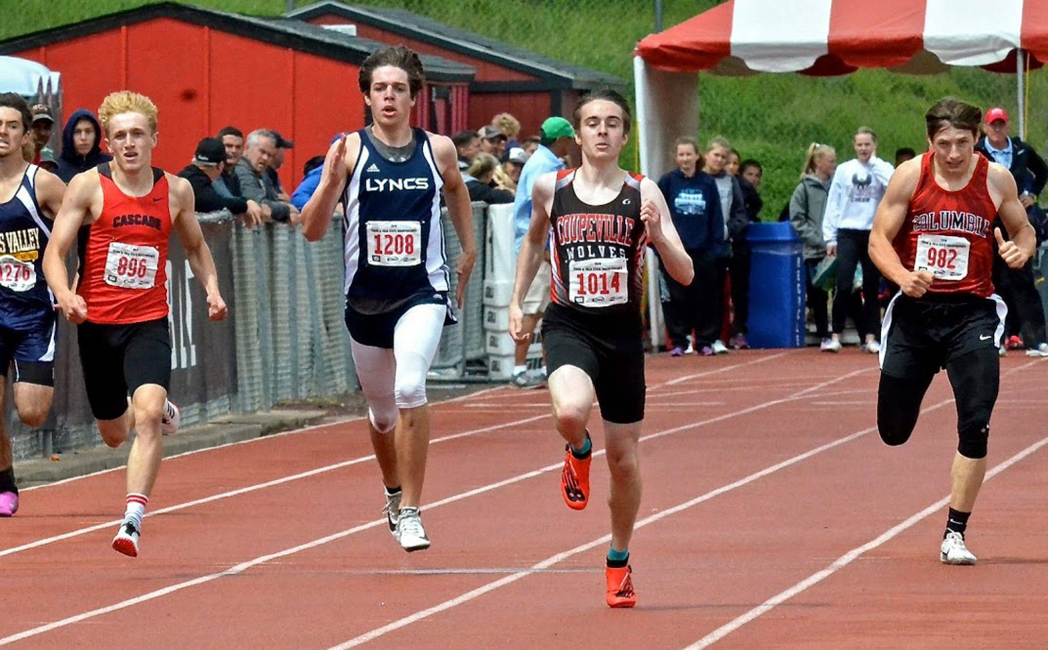 Coupeville’s Danny Conlisk, second from right, runs to first place and a school record in the 400 meters. (Photo by Karen Swegler)
