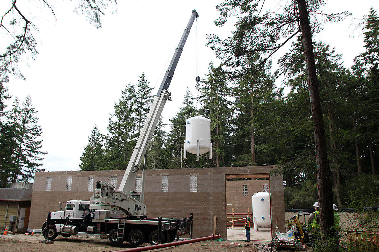 A large tank is lowered into the new facility at Coupeville’s water treatment plant Monday. Photo by Laura Guido/Whidbey News-Times