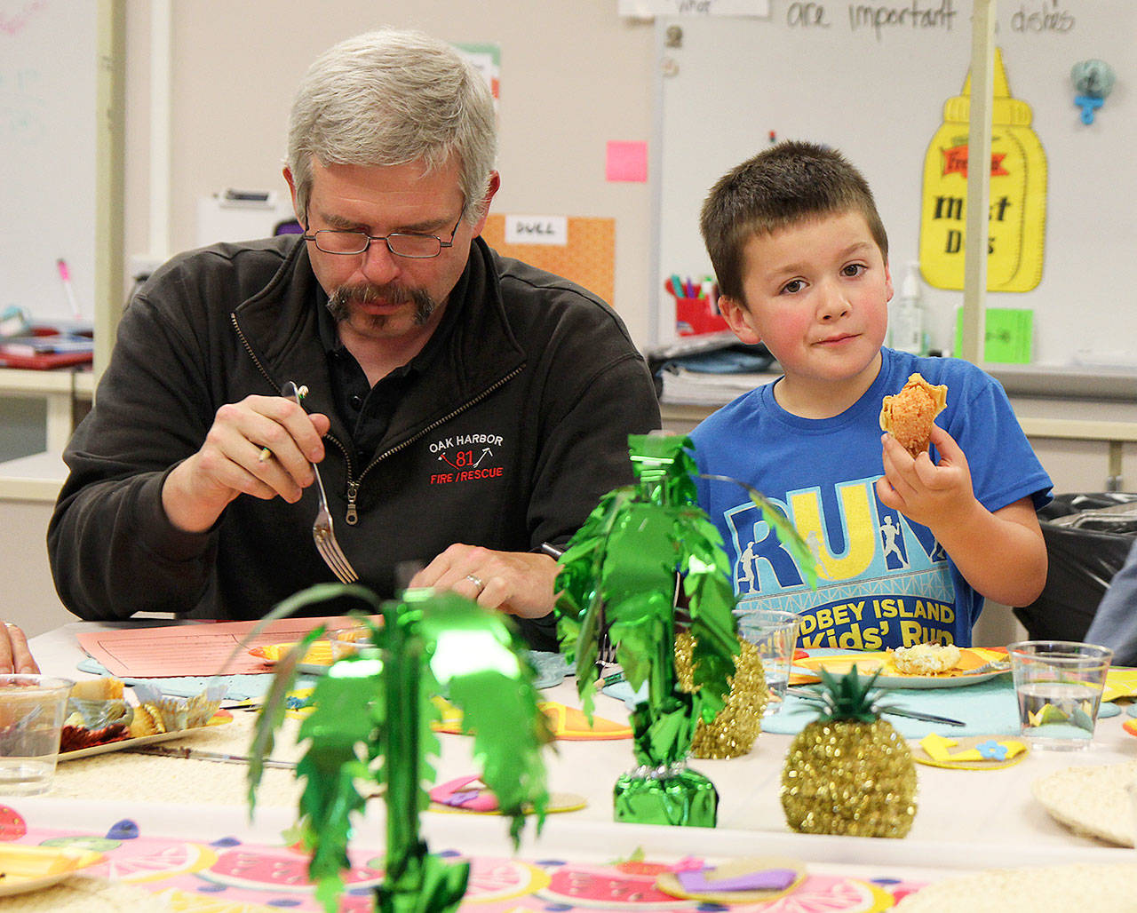 Cameron Hopkins and Arthur Holcomb. taste one of the Cupcake Wars entries Friday afternoon at North Whidbey Middle School. Photo by Laura Guido/Whidbey News-Times