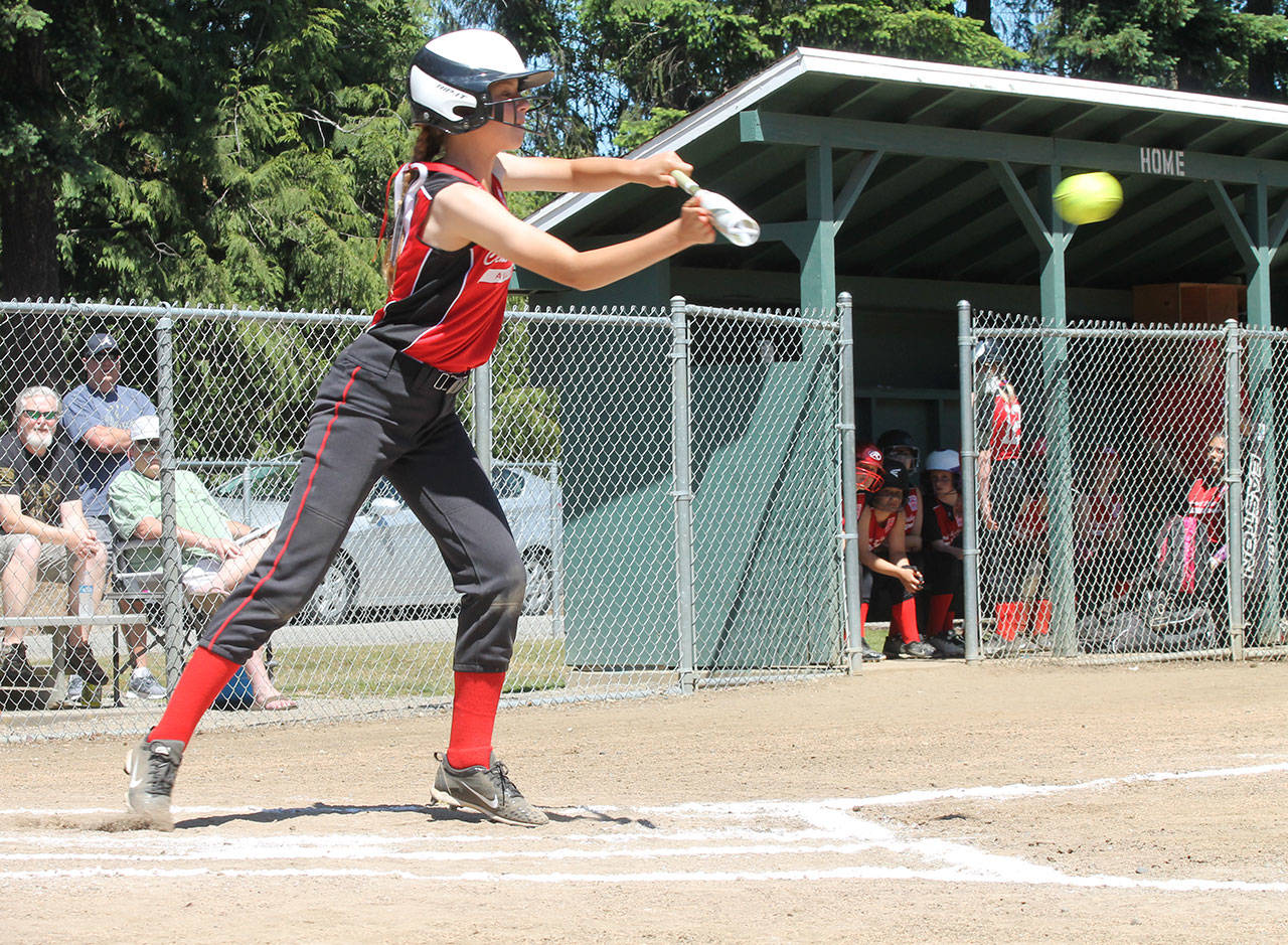 Mia Farris bunts for a base hit for Central Whidbey. (Photo by Jim Waller/Whidbey News-Times)