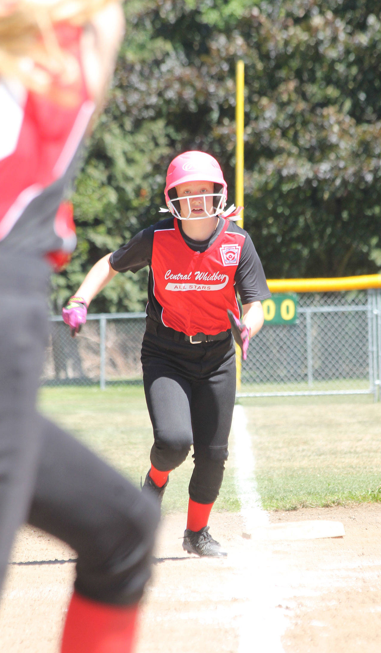 Jada Heaton races home as batter Savina Wells follows through on a base hit.(Photo by Jim Waller/Whidbey News-Times)