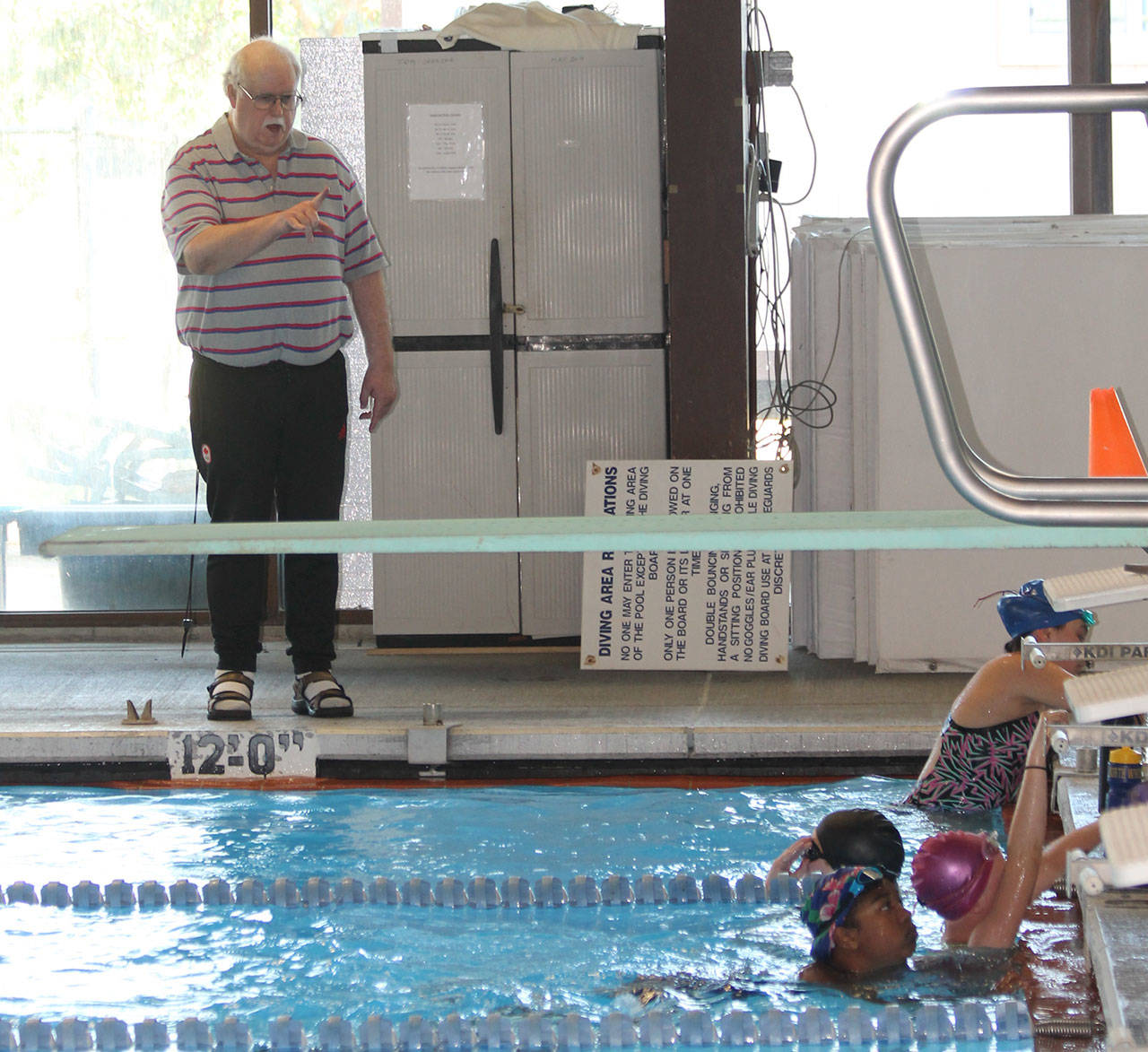North Whidbey Aquatic Club coach Frank Comerford, left, instructs several of his team members at practice last week. (Photo by Jim Waller/Whidbey News-Times)