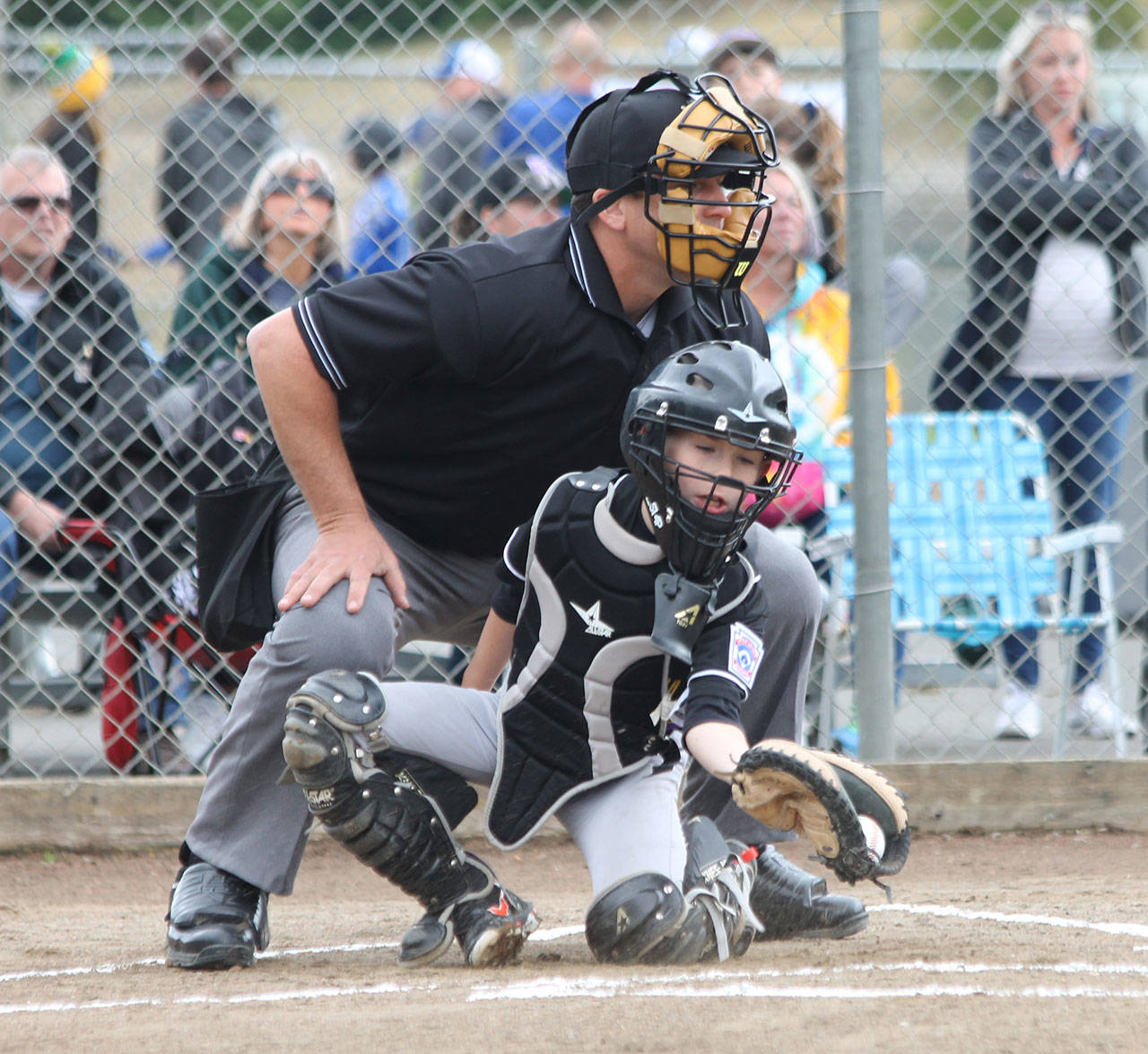 Catcher Jack Ferrell snags an outside pitch as umpire Jim Honold looks on.(Photo by Jim Waller/Whidbey News-Times)