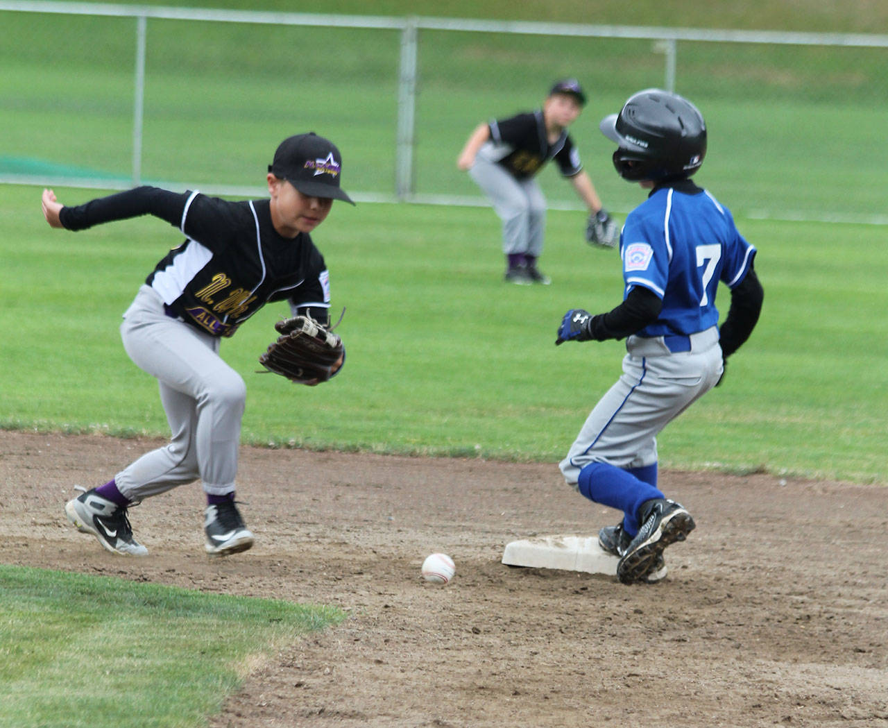 Shortstop Conner Reed runs down a loose ball for North Whidbey.(Photo by Jim Waller/Whidbey News-Times)