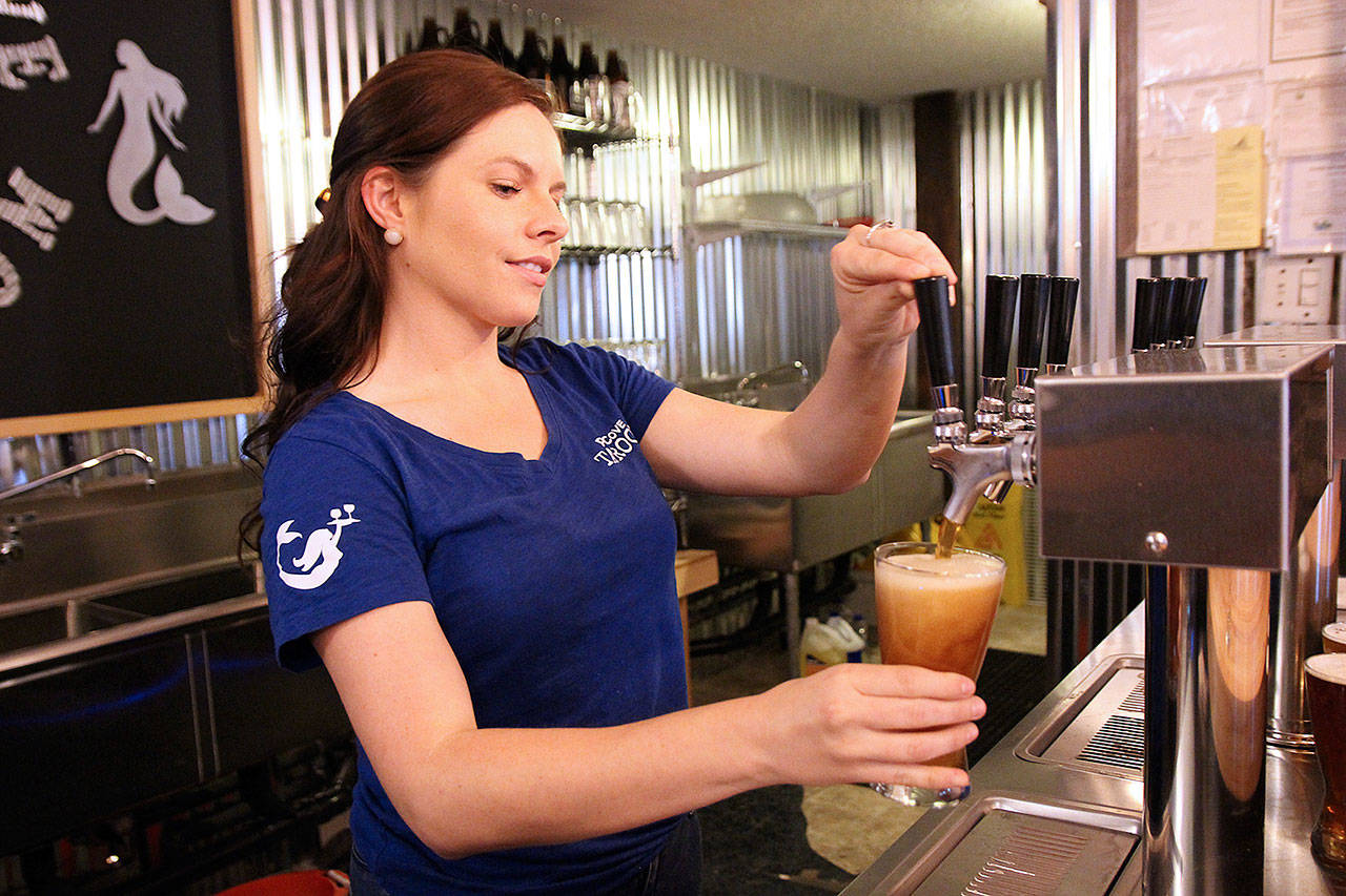 Hannah Gibbons pours a beer at Penn Cove Brewing Company’s new taproom in Oak Harbor. Photo by Laura Guido/Whidbey News-Times